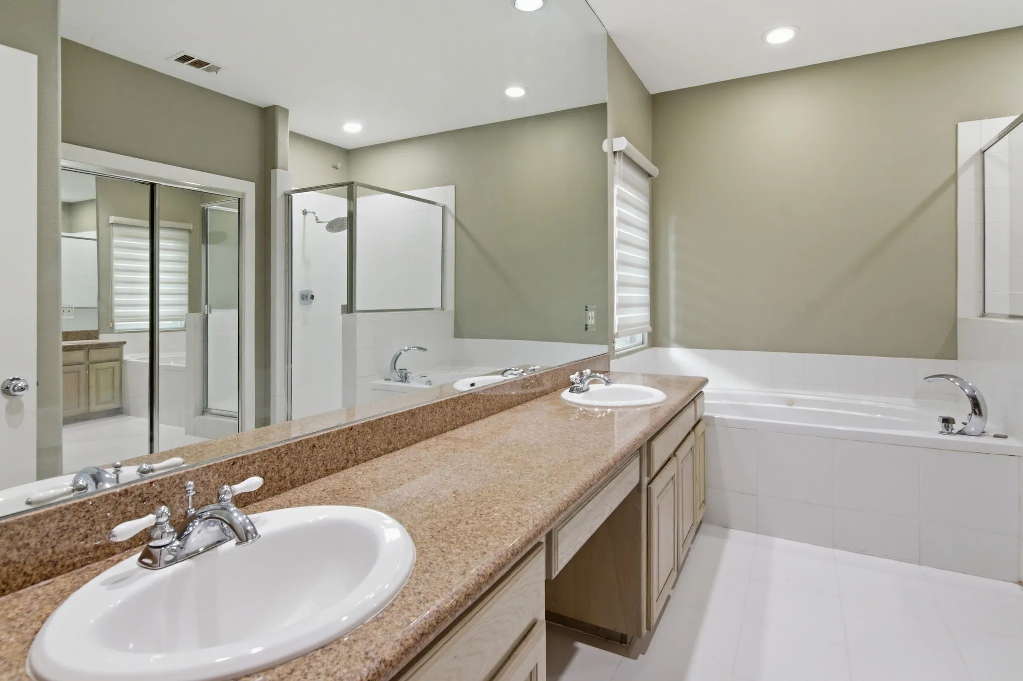 Dual vanity with stone-finish countertop, undermount sinks, and chrome fixtures