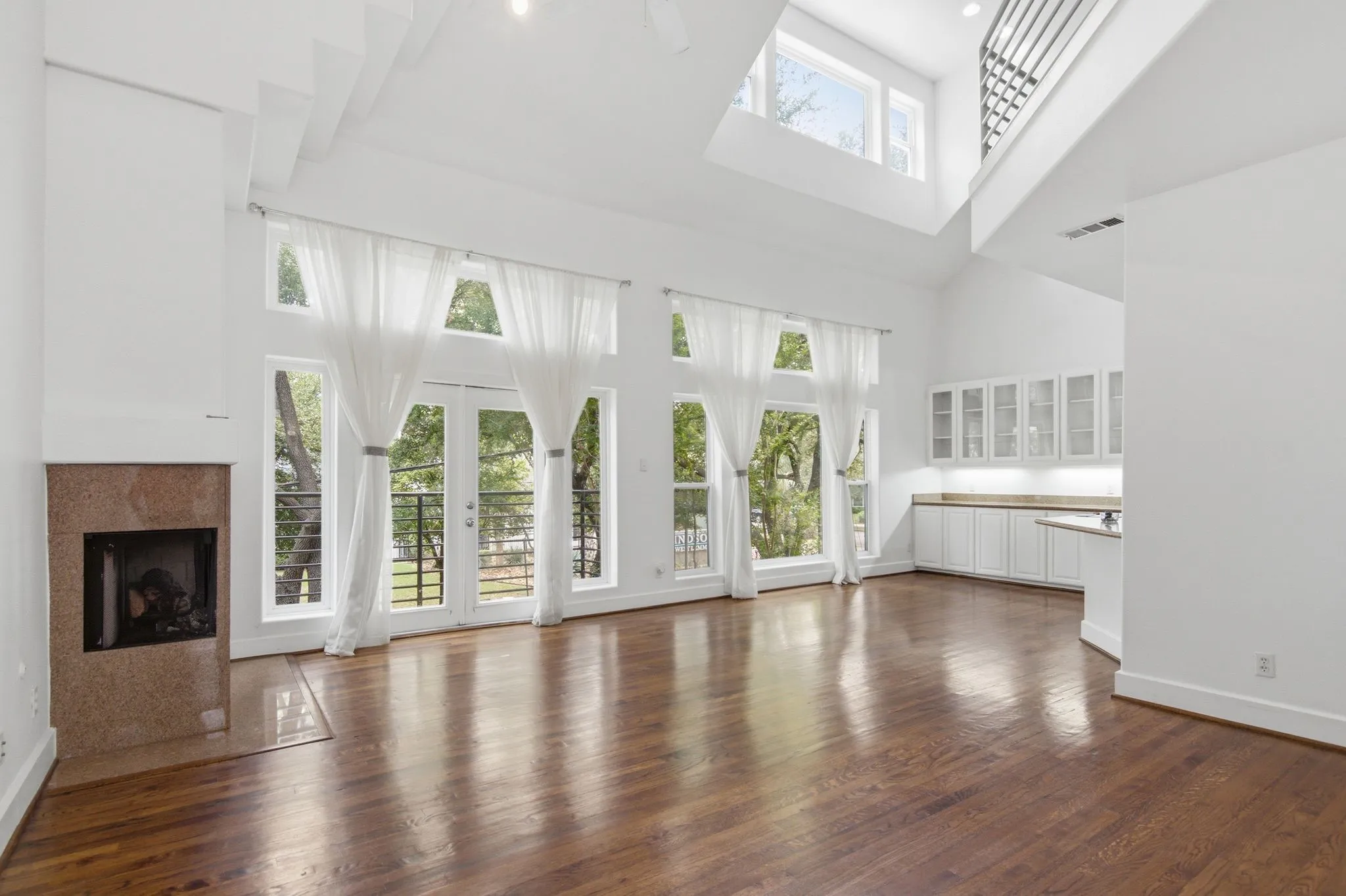 Soaring ceilings with exposed beams and upper windows