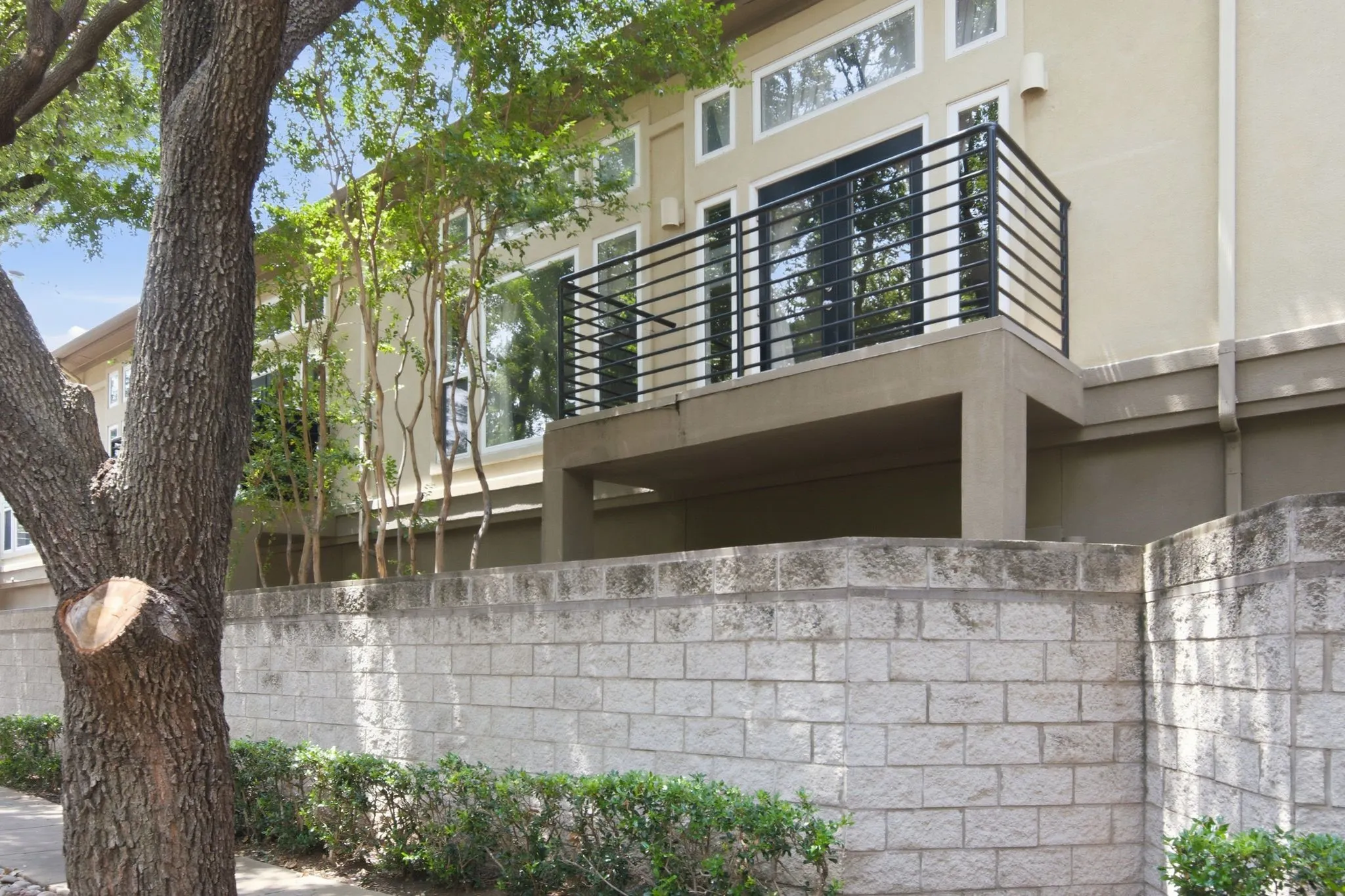 2nd Story balcony with Black Metal Railing that overlooks pedrestrian friendly, Tree-lined Bowser Street