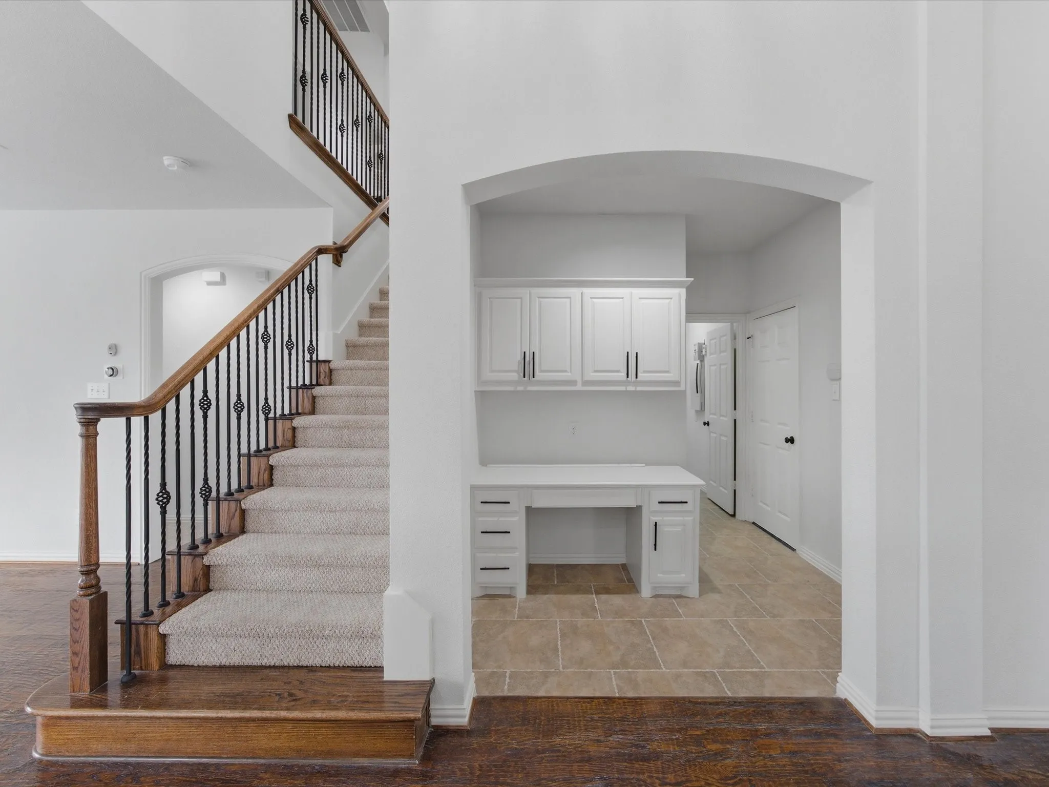 Staircase to second level and built-in desk area