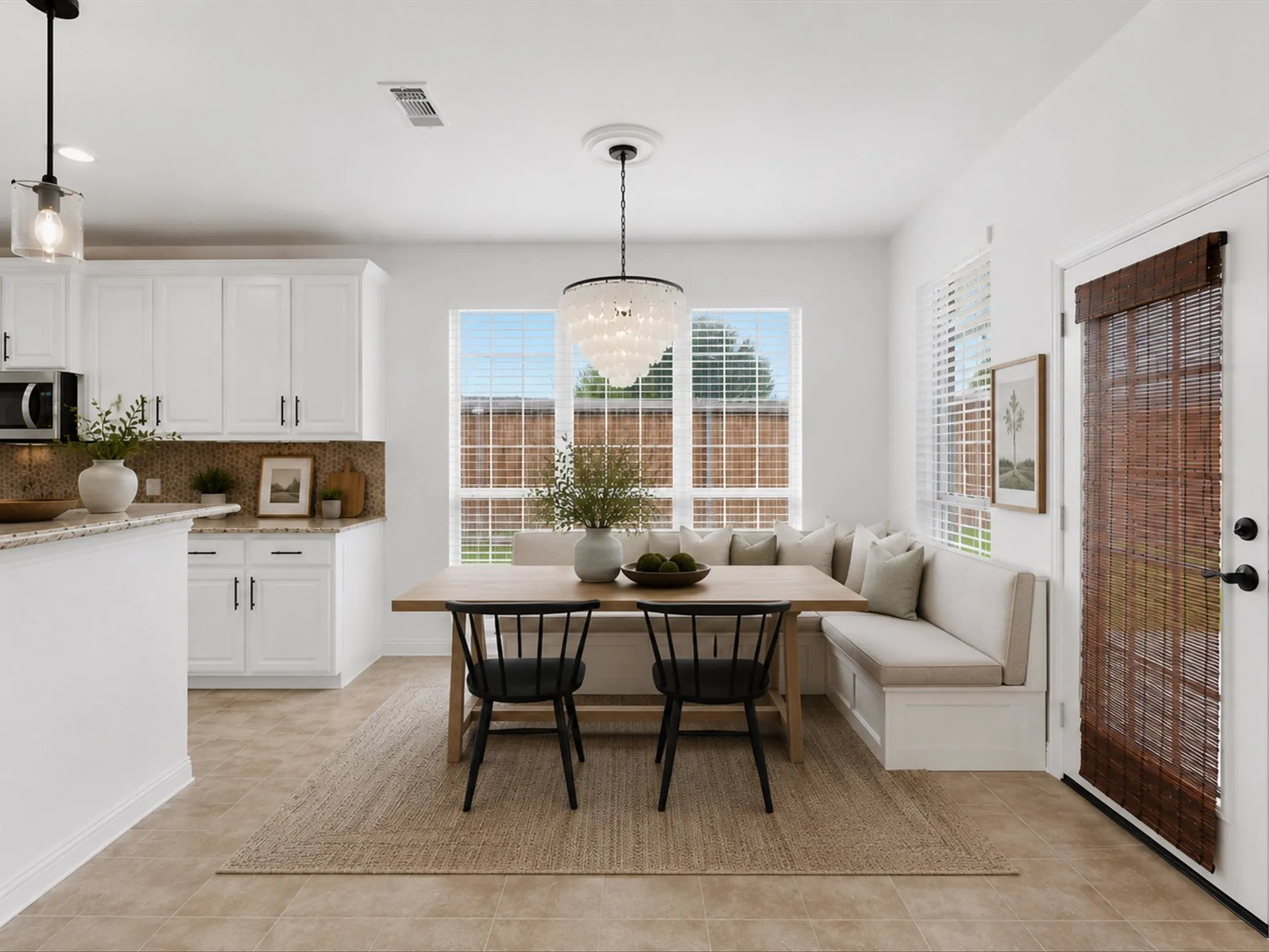 Breakfast nook featuring an integrated banquette, a contemporary chandelier, and ample natural light