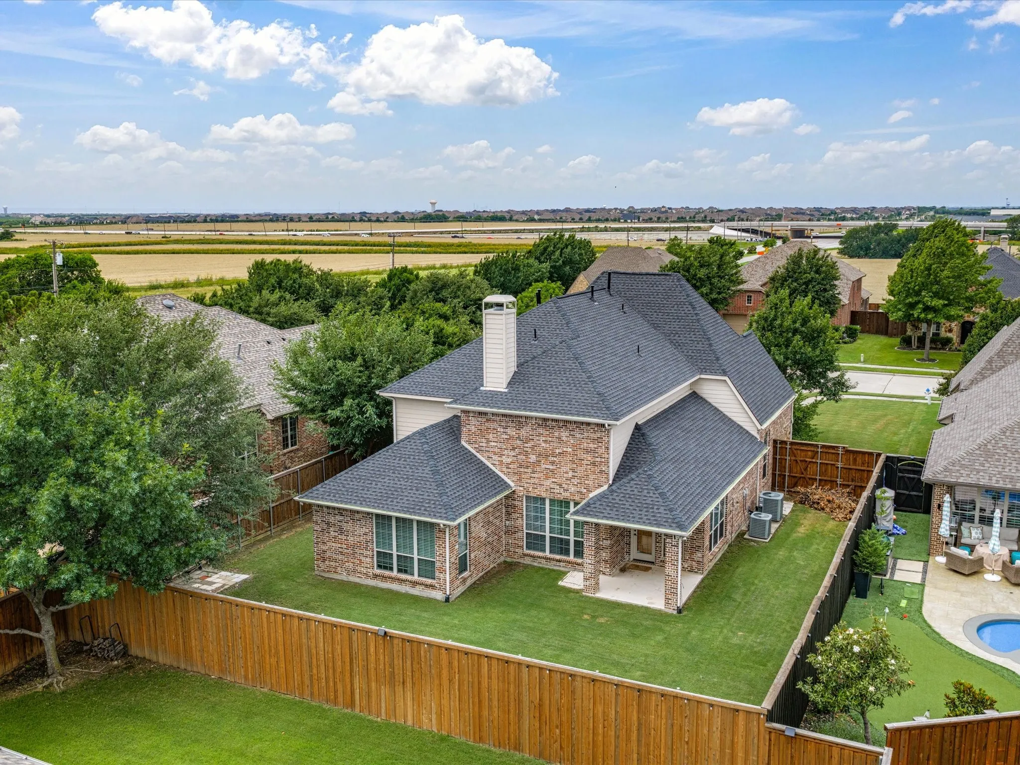 Brick and siding exterior with a dark shingle roof