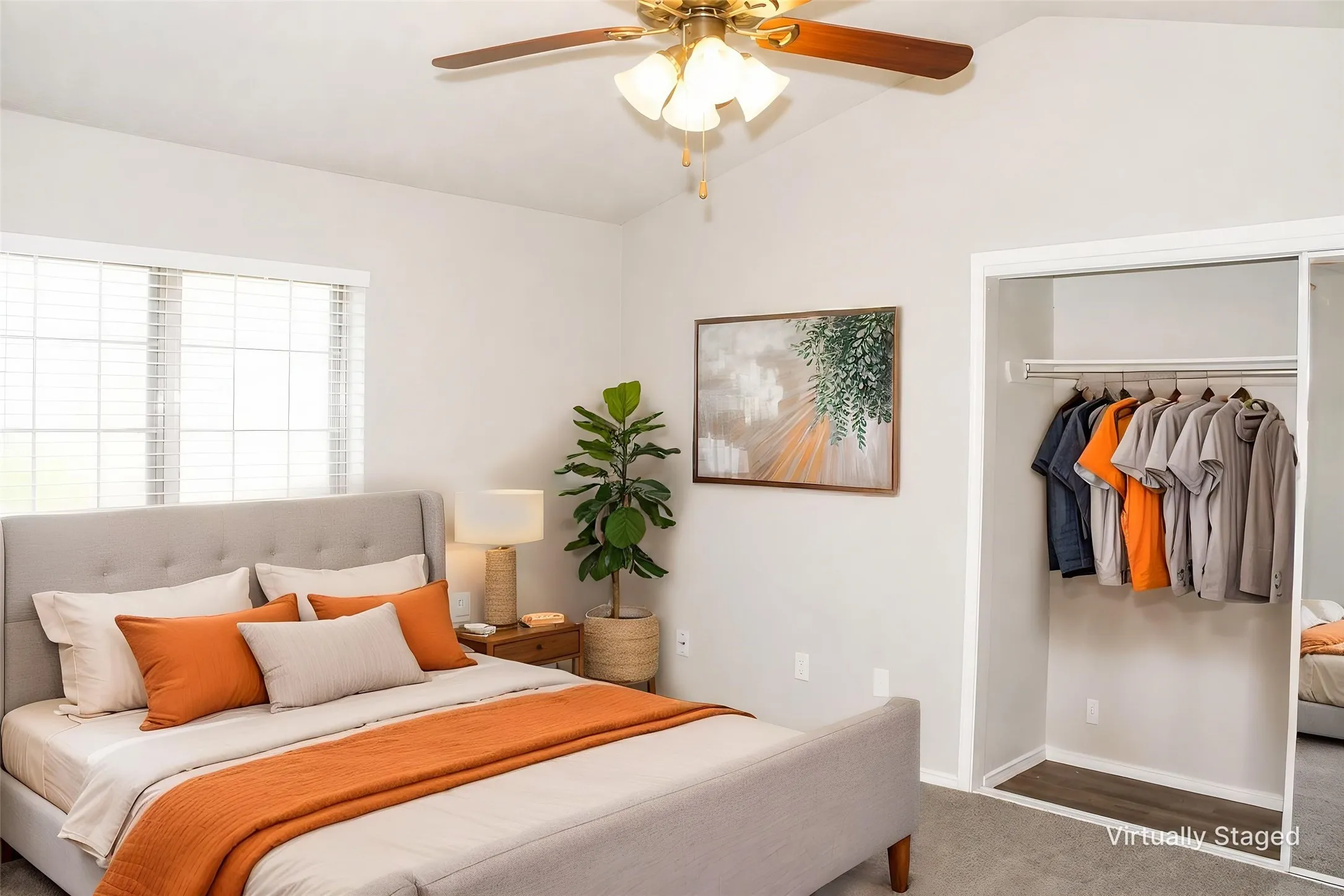 Vaulted ceiling, ceiling fan with integrated lighting, window with blinds, carpeted flooring, and a closet with a sliding mirrored door