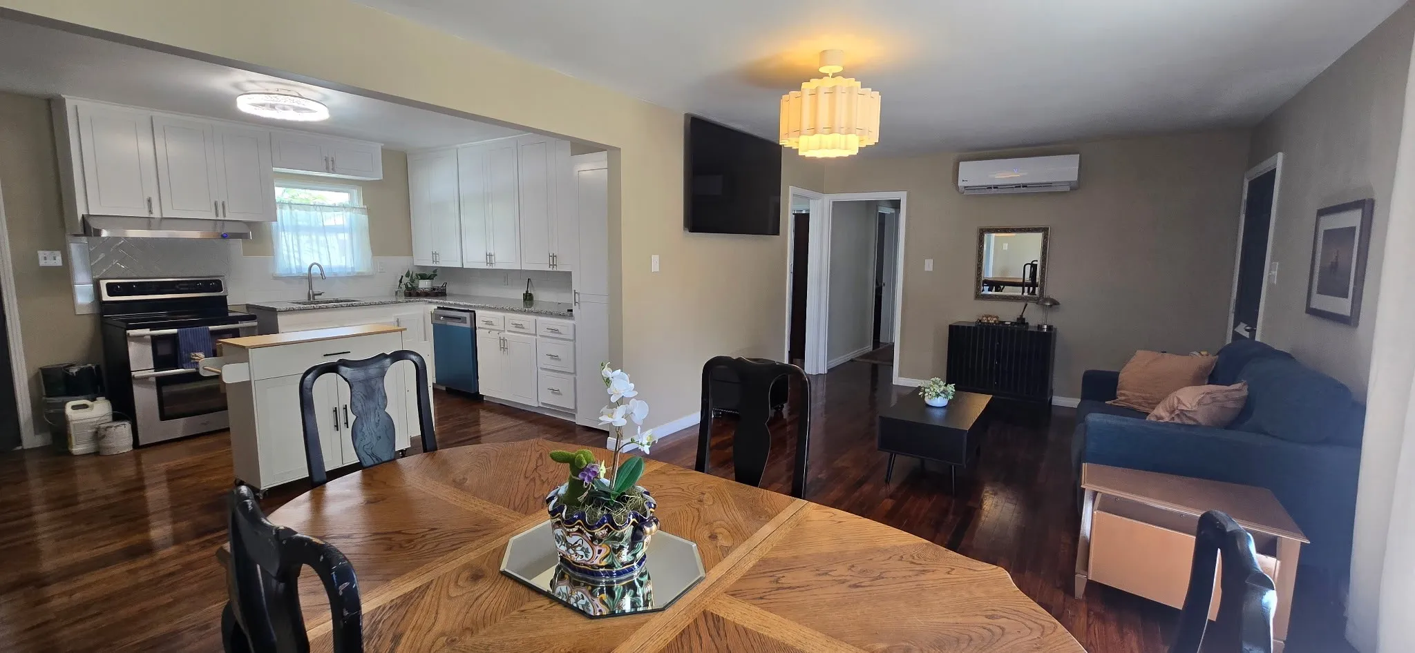 Spacious open-concept living area featuring wood-finish flooring