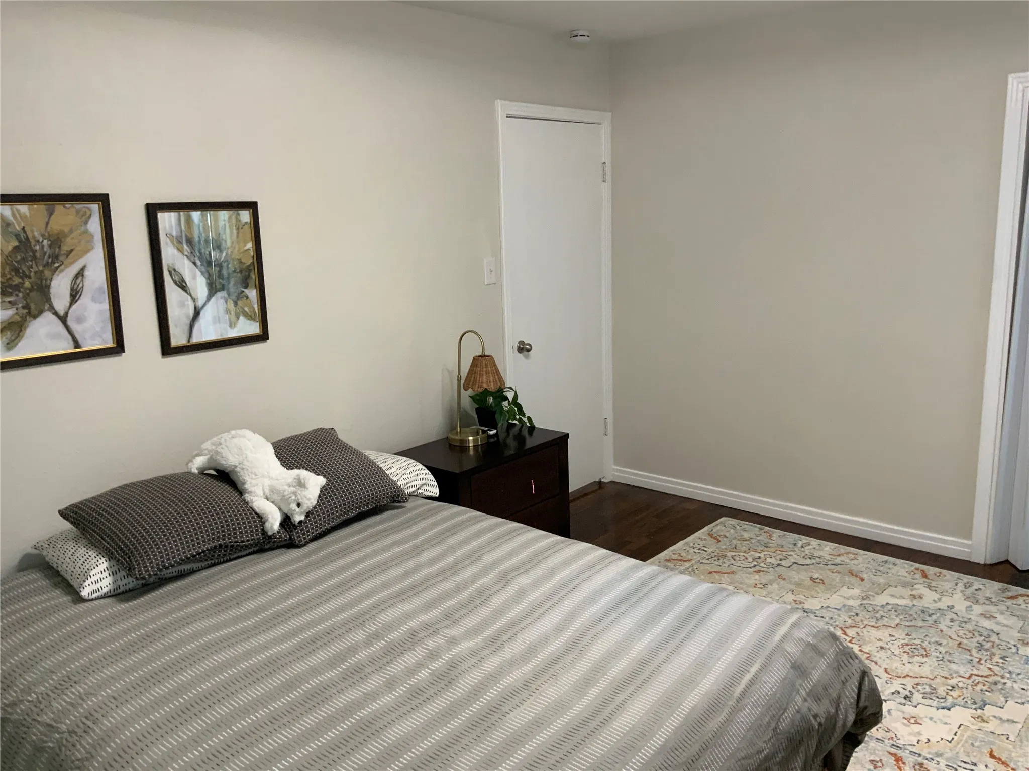 Neutral-toned walls complement dark wood-finish flooring