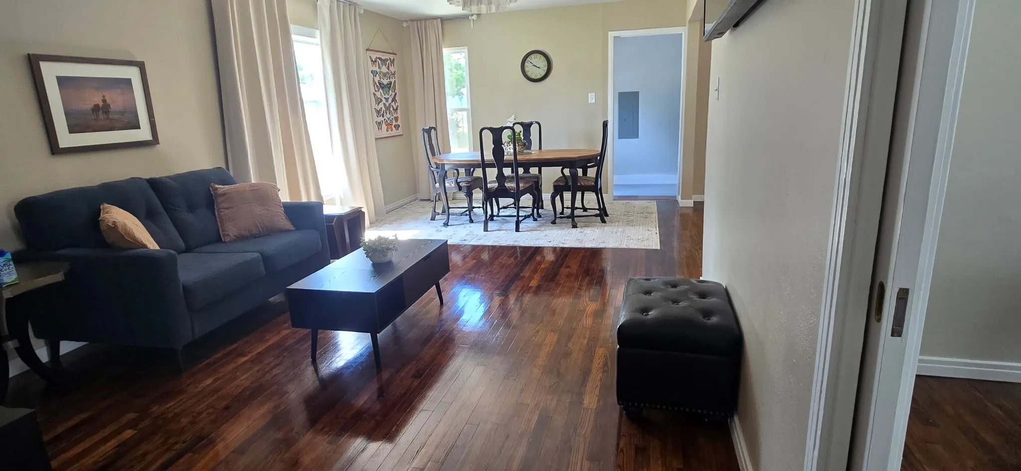Rich wood-finish flooring extends through this open-concept living and dining area