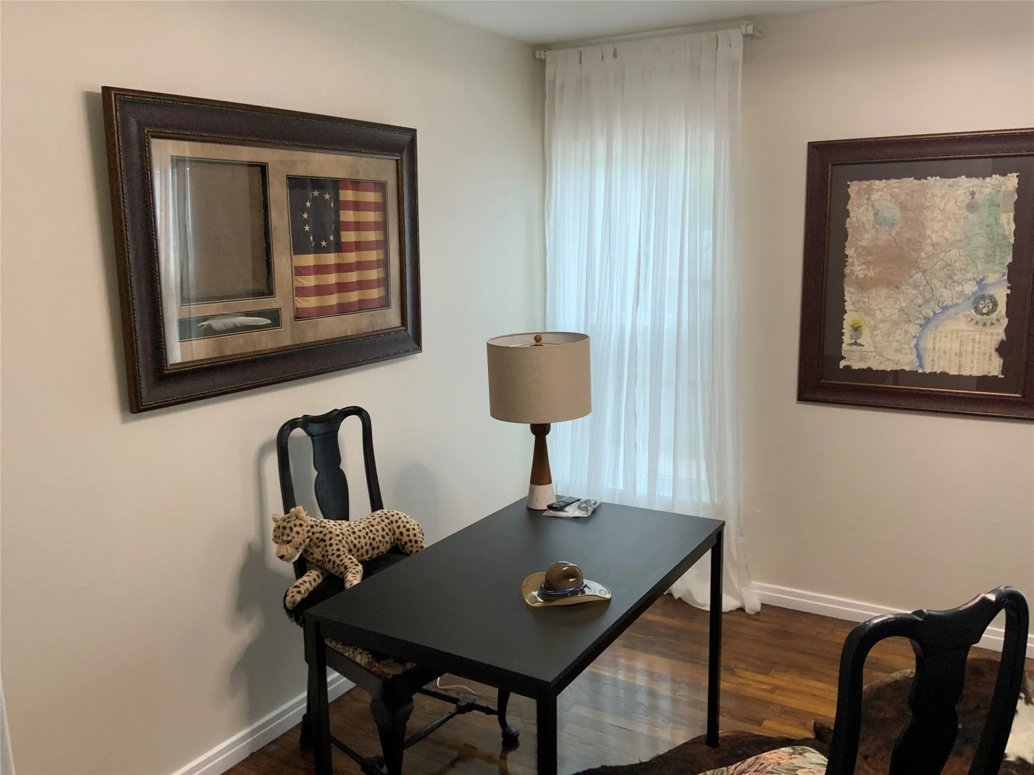 Office or bedroom Neutral wall color with white trim and wood-finish flooring