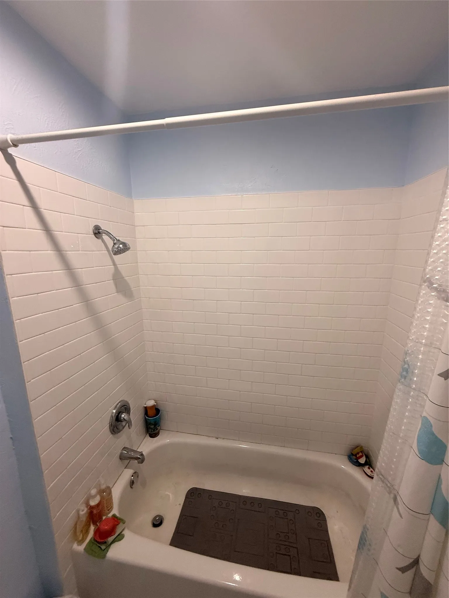 White subway tile surround with light blue painted walls