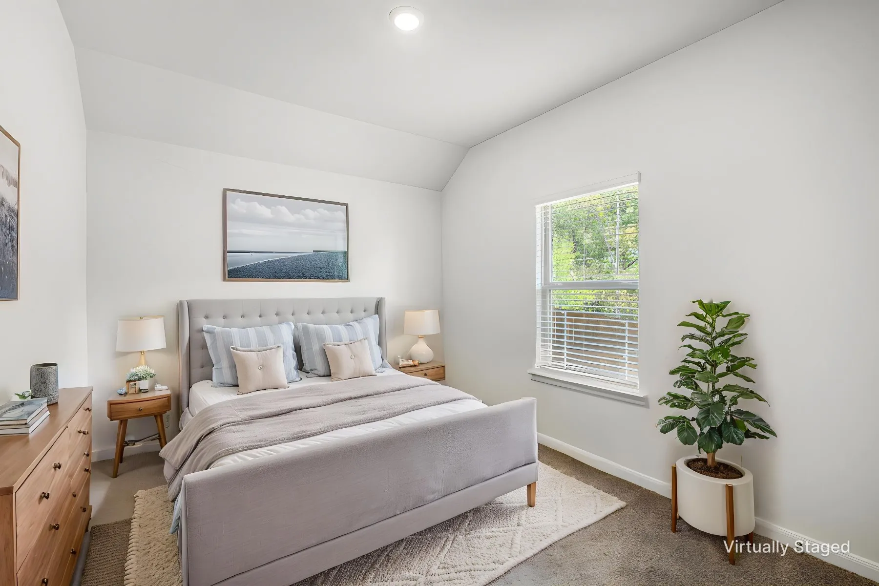 Virtually staged - View as Bedroom #2 with lofted ceiling, carpet, and a window looking out to the back yard.