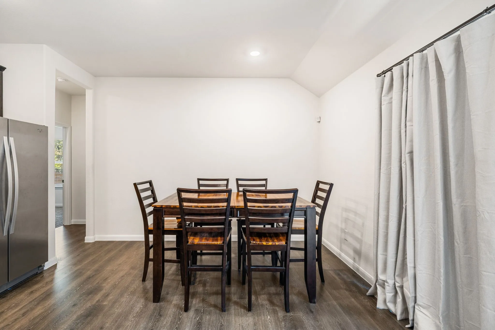Dining space in the eat-in kitchen, adjacent to sliding glass door leading to back yard.