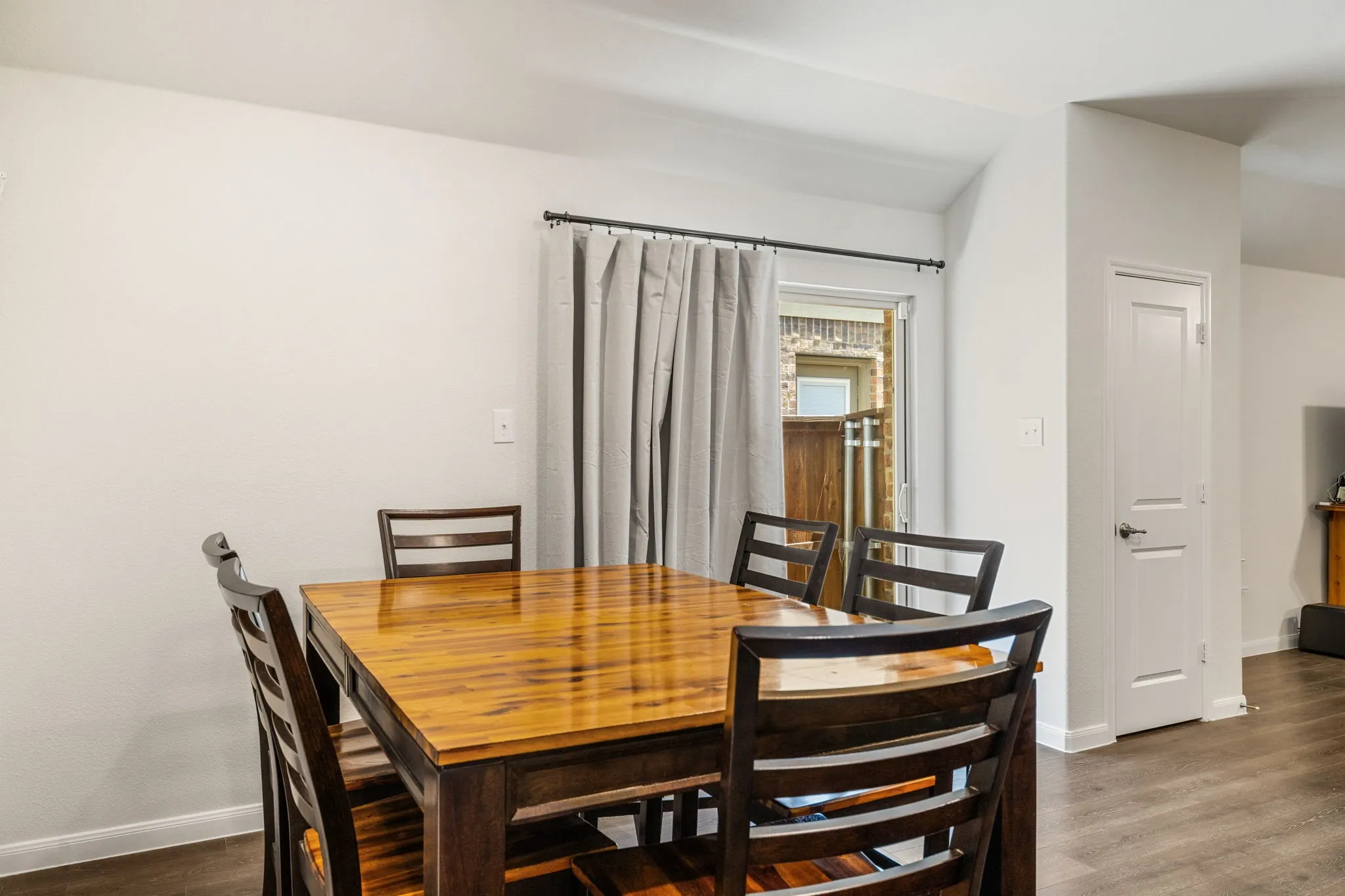 Dining space in the eat-in kitchen, adjacent to sliding glass door leading to back yard.