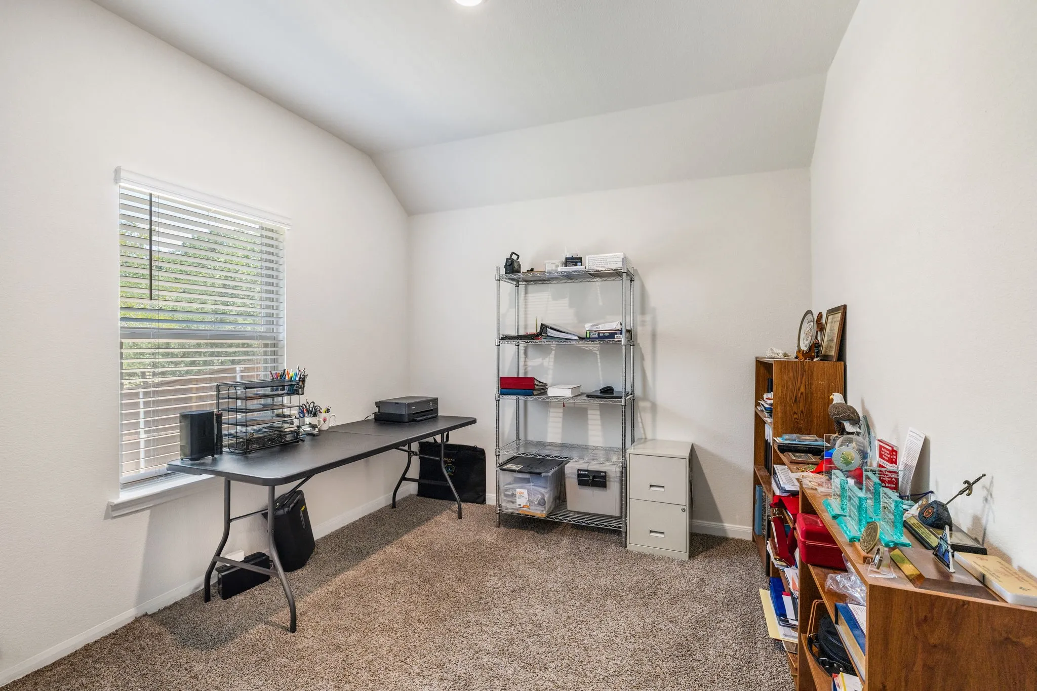 Bedroom #3 - currently used as private office space featuring carpet flooring and large window.