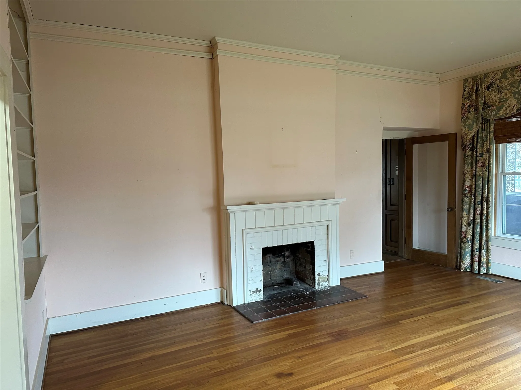 Living area featuring a traditional fireplace with a white mantel and tiled hearth