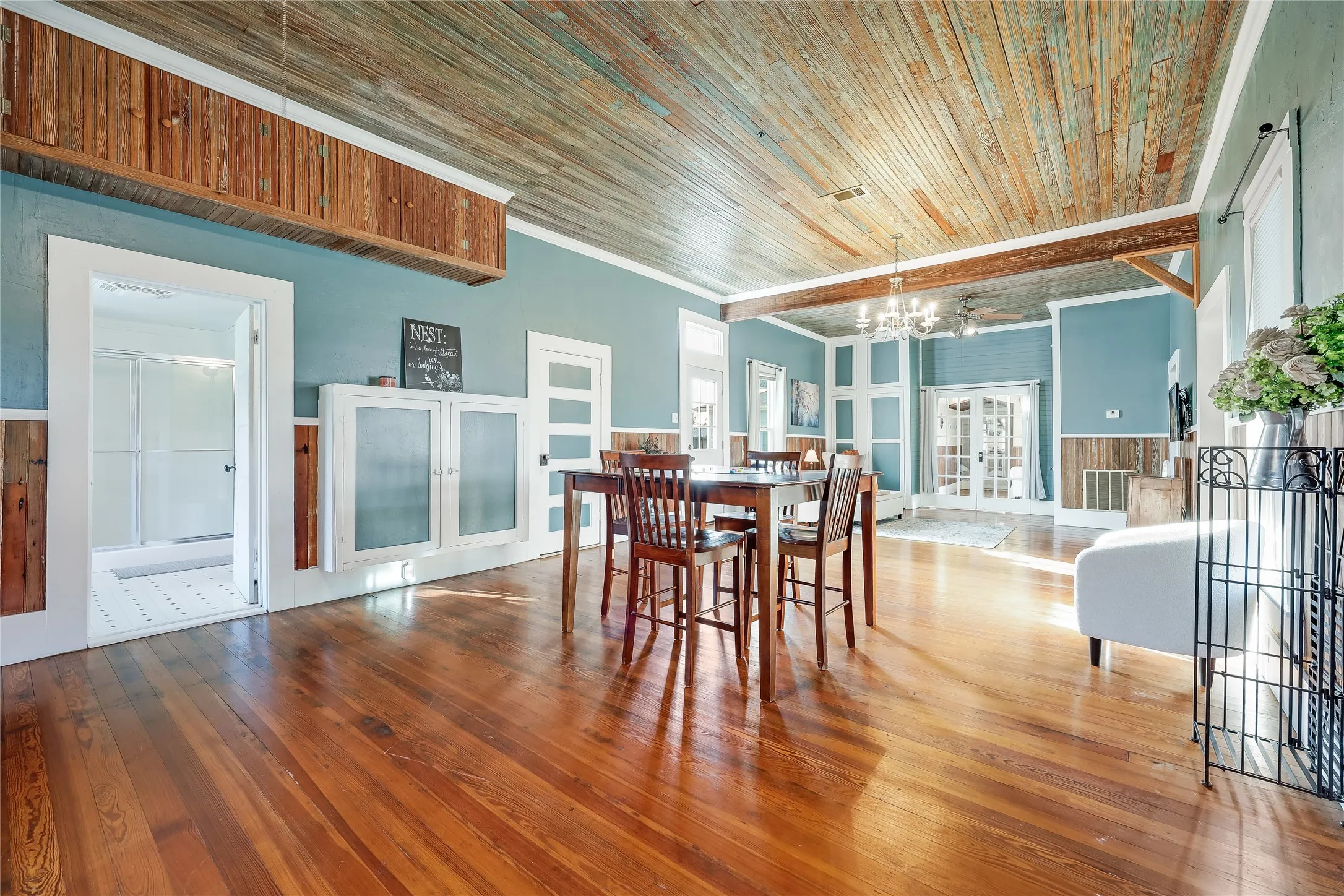 Open concept living space featuring wood-finish flooring and a wood plank ceiling