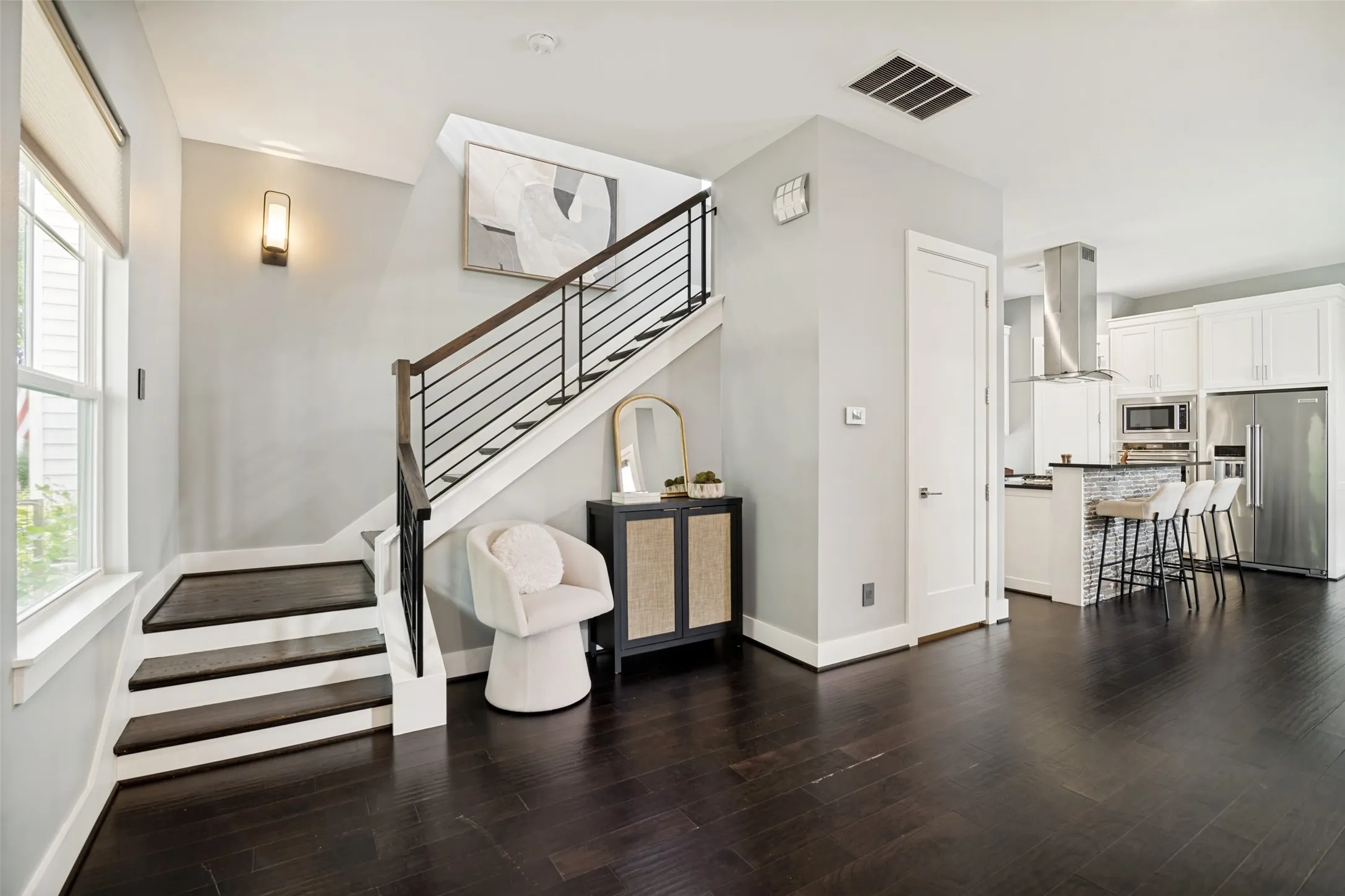 Entry boasting hard wood floors and an open floor plan
