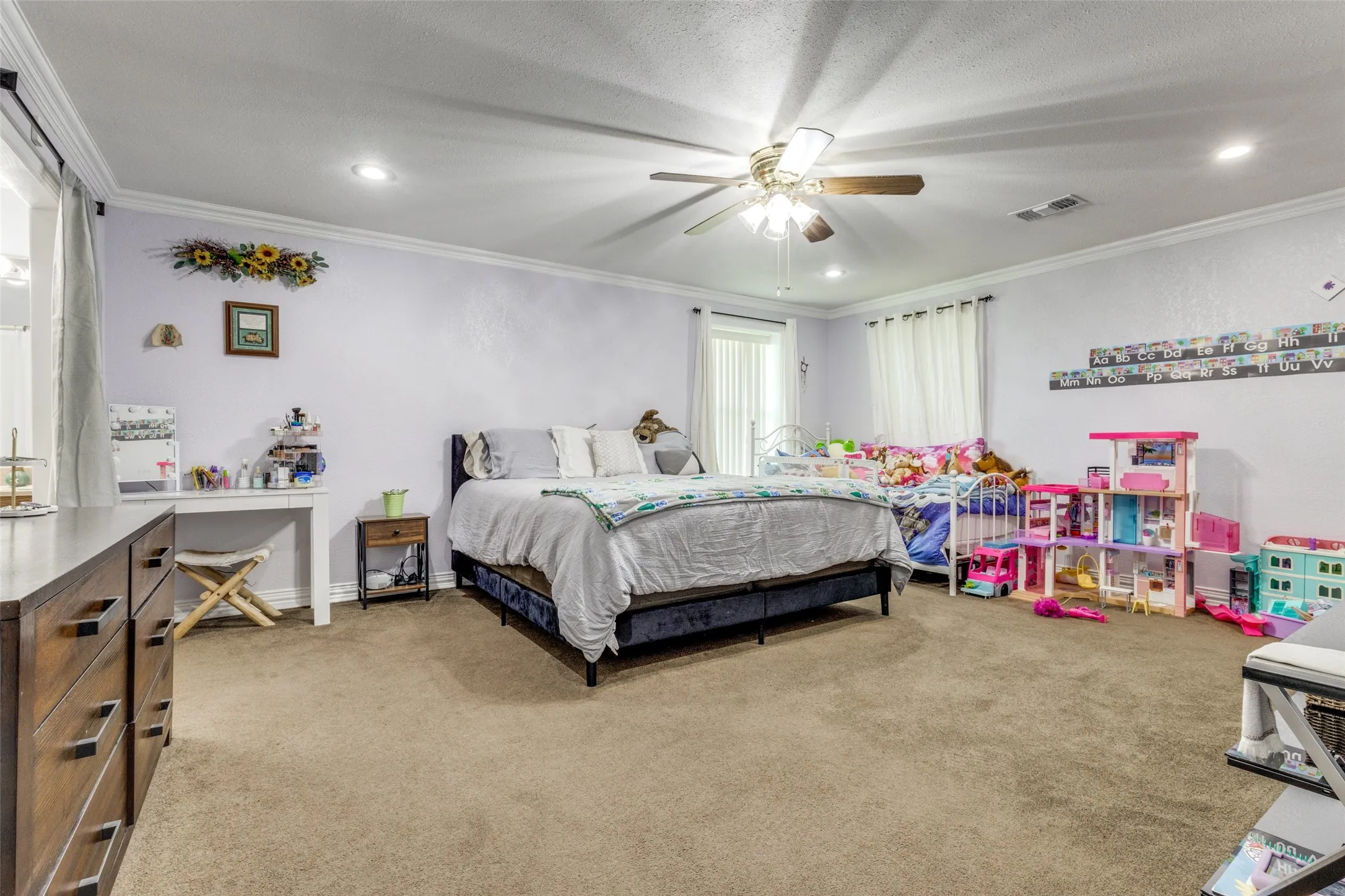 Bedroom featuring light carpet, crown molding, recessed lighting, ceiling fan, and a textured ceiling