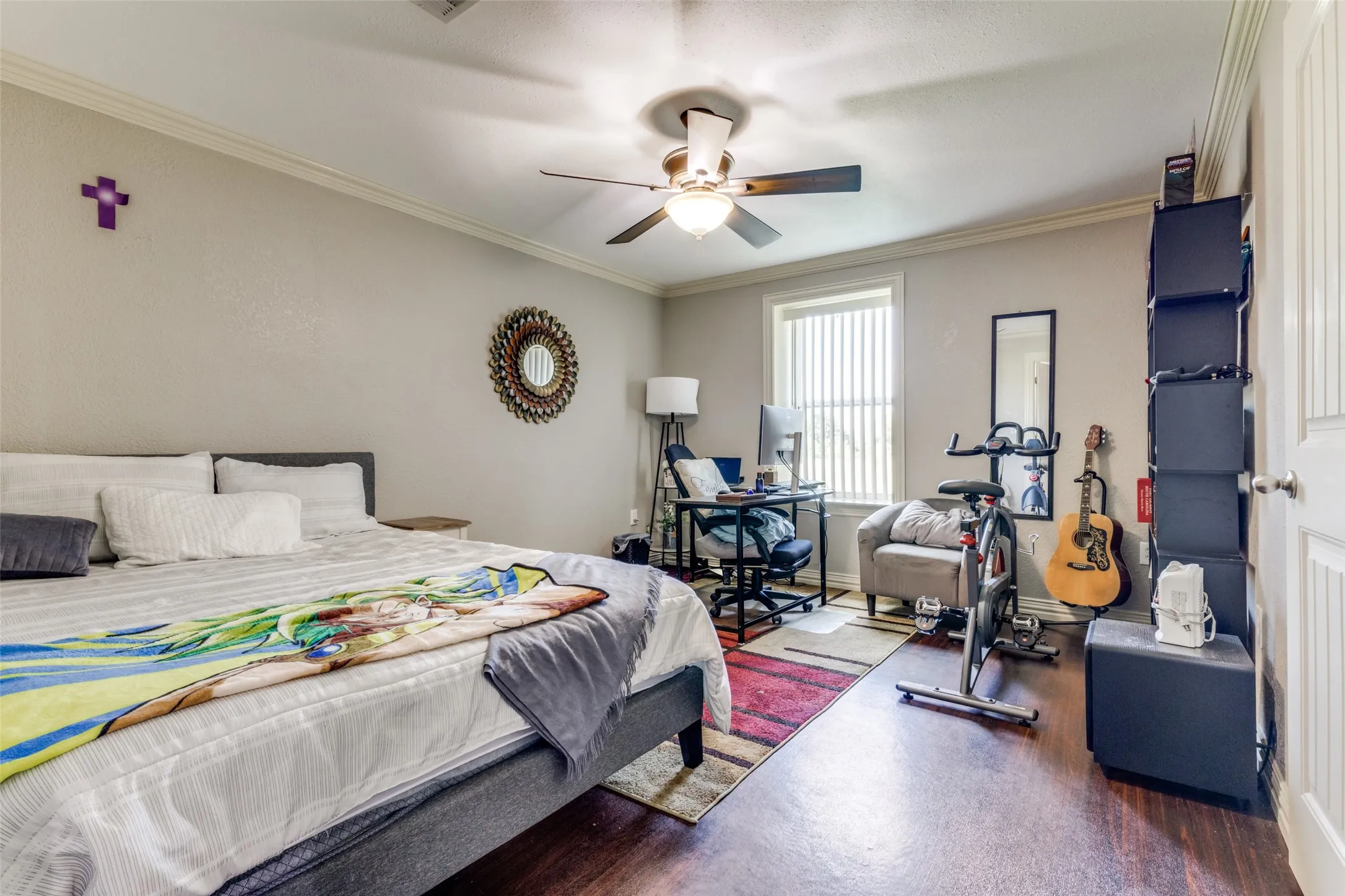 Bedroom with crown molding, a ceiling fan, and wood finished floors