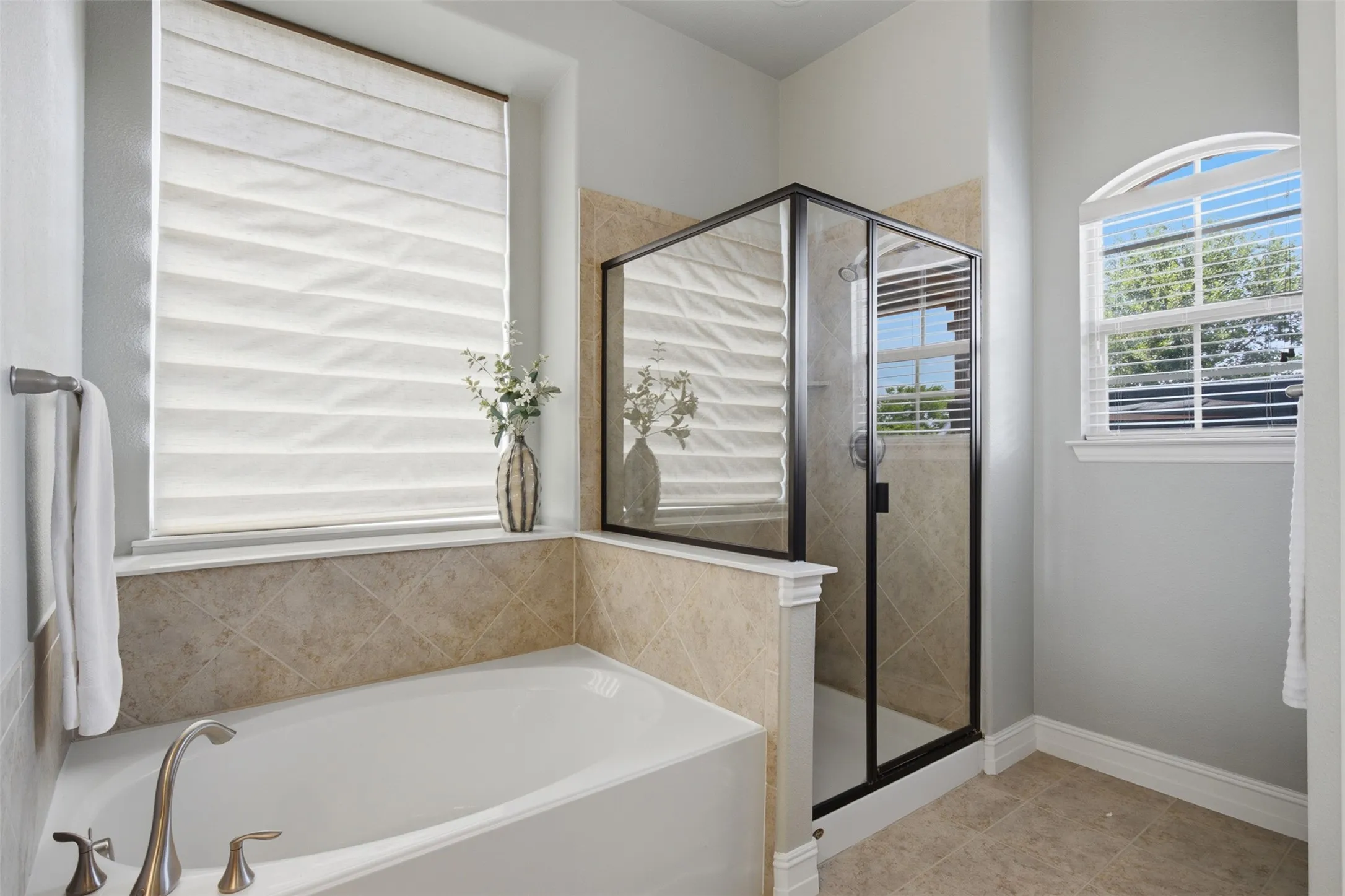 Relaxing garden tub and separate shower complete the first-floor primary bathroom.