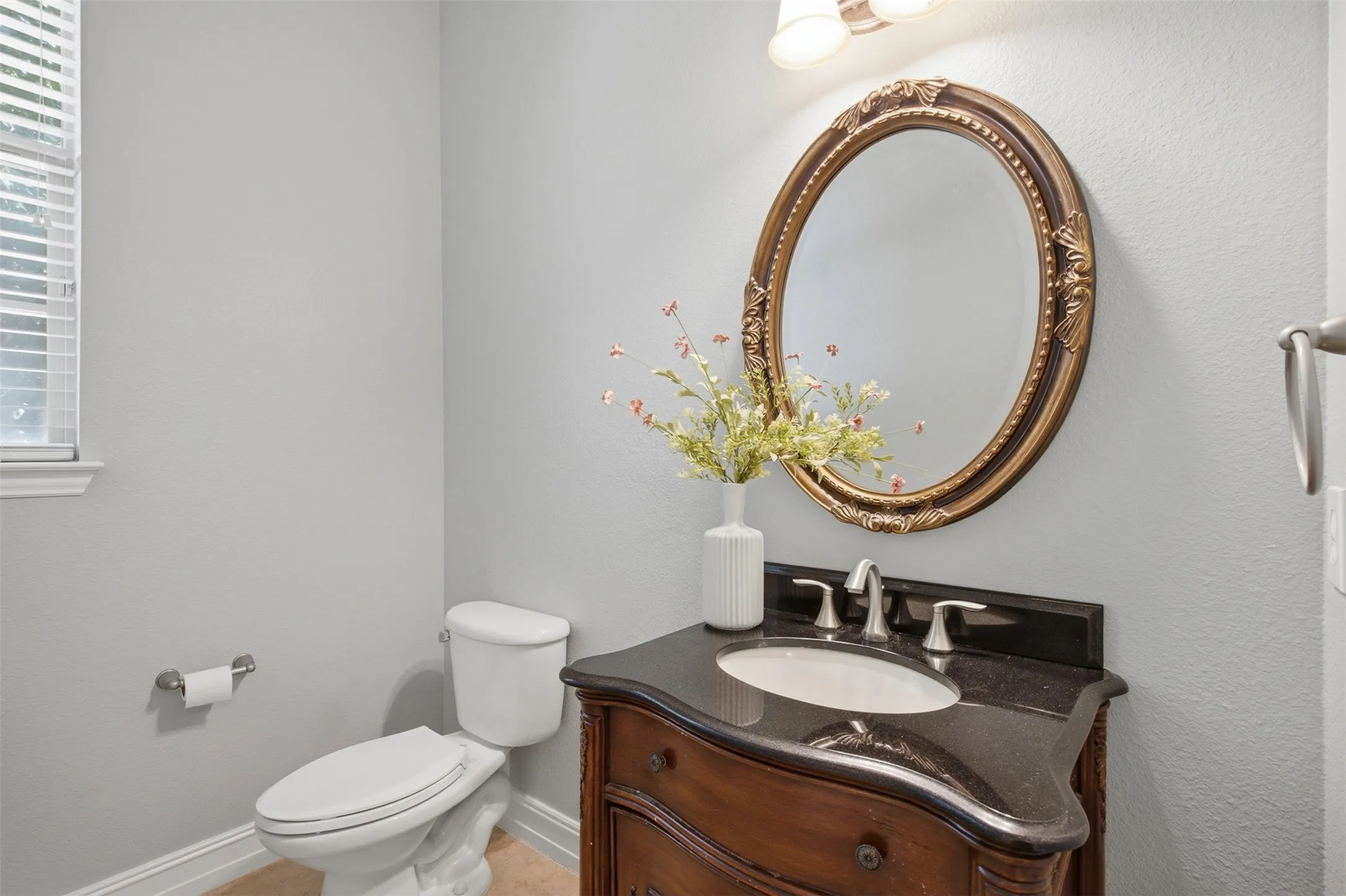 Well-positioned half bathroom providing convenience for guests and everyday living.