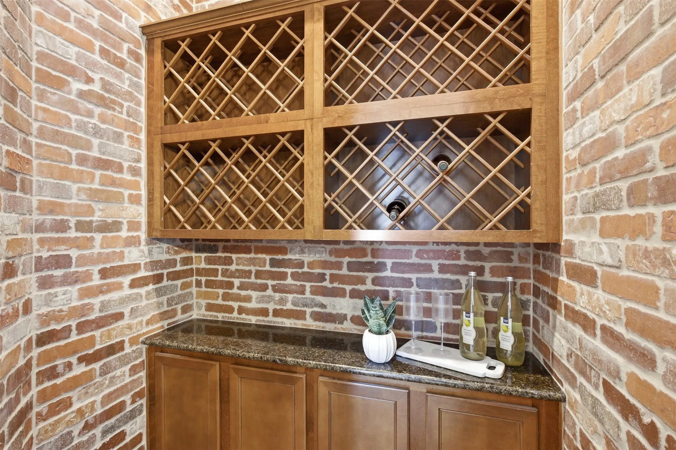 A striking wine cellar adjoining the formal dining room features elegant wrought iron doors and a charming brick-lined entry, creating a distinctive space for wine storage, entertaining, and memorable dinner gatherings.
