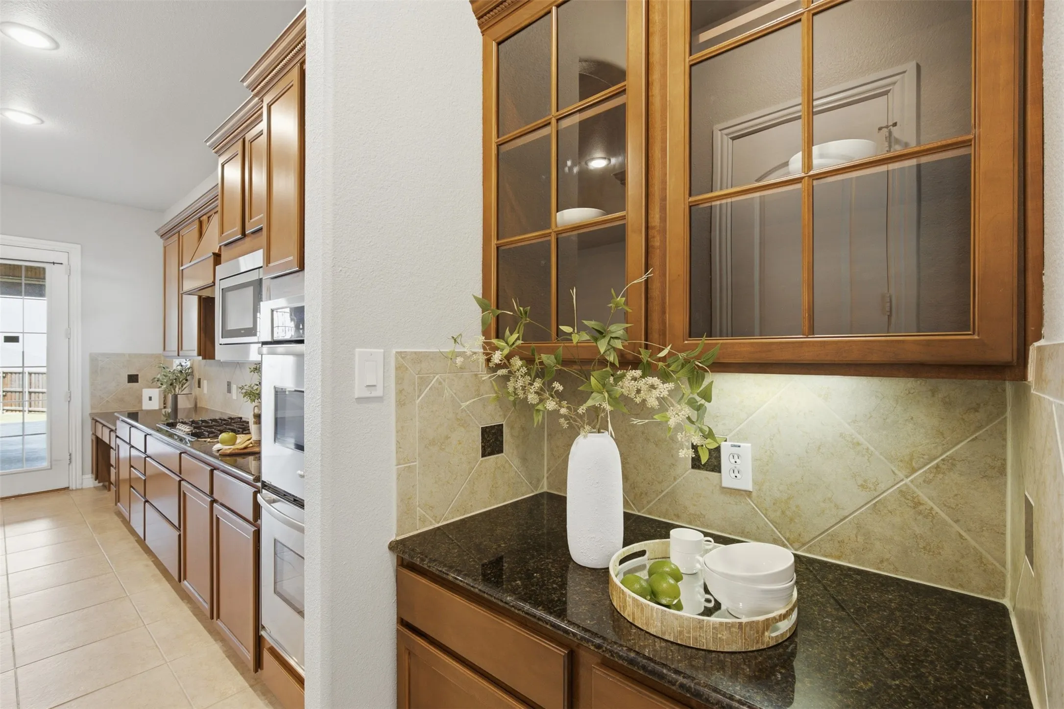 Convenient butler’s pantry connecting the kitchen and formal dining room with additional preparation and storage space.