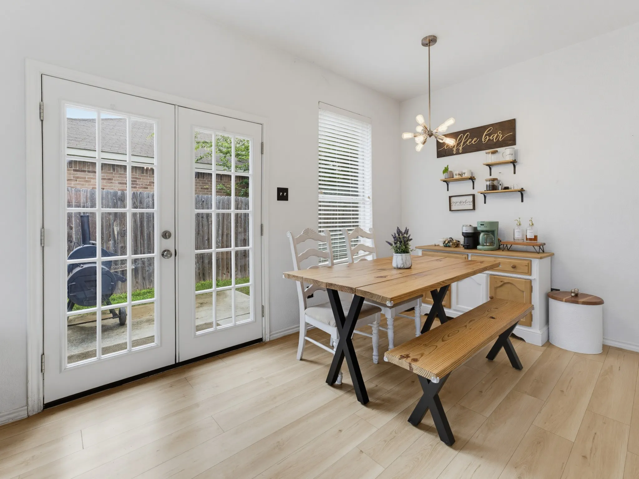 Bright dining space featuring light wood-finish flooring and white walls