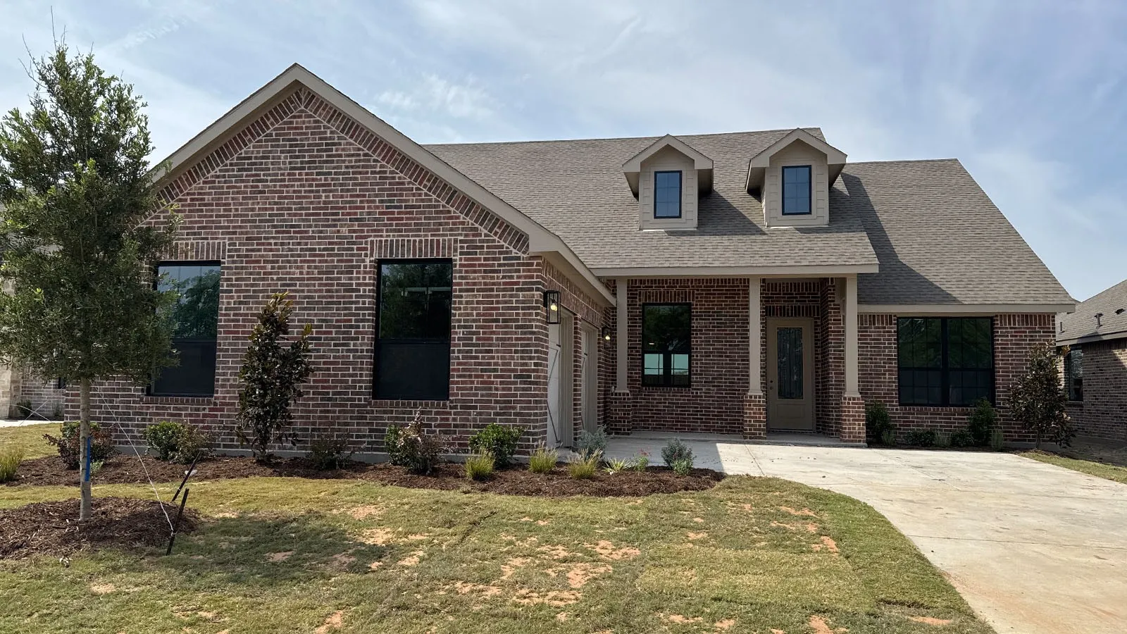 Brick exterior with a gabled roof and dormer windows