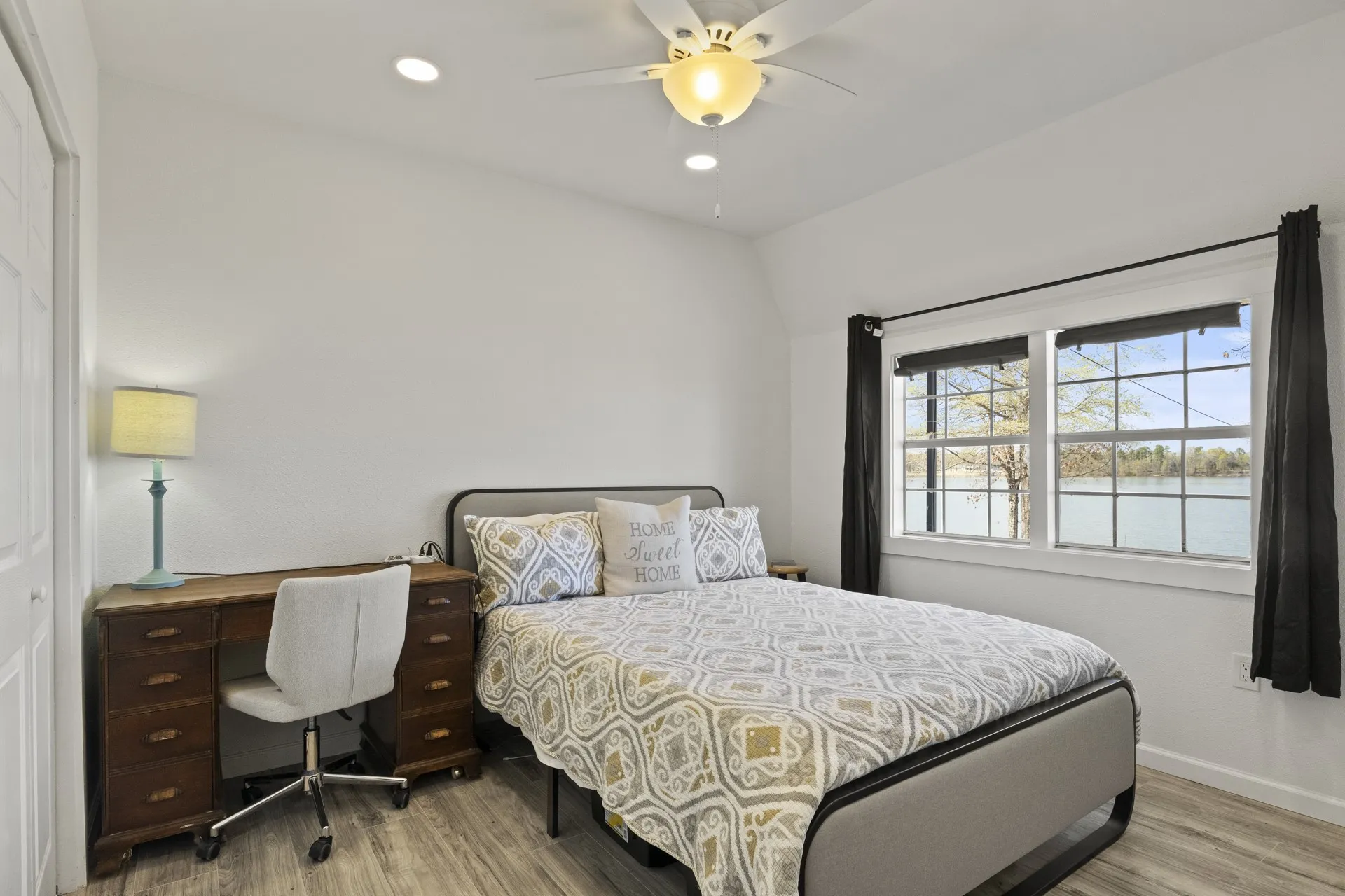 Bedroom featuring hardwood / wood-style flooring, ceiling fan, and lofted ceiling