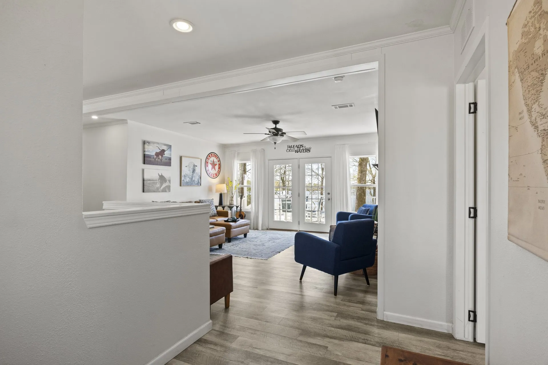 Hall featuring french doors, ornamental molding, and wood-type flooring