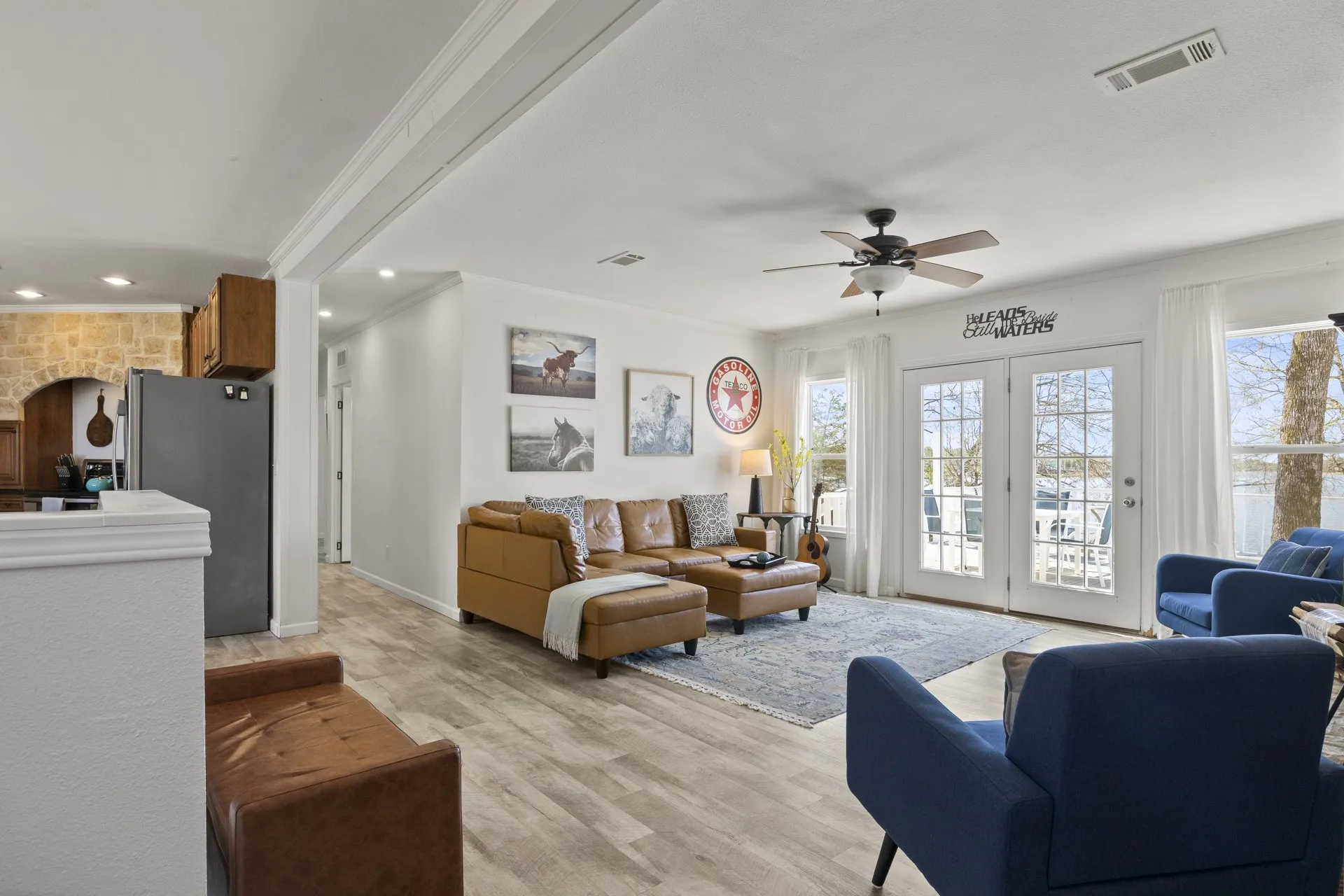 Living room featuring french doors, ornamental molding, light hardwood / wood-style flooring, and ceiling fan