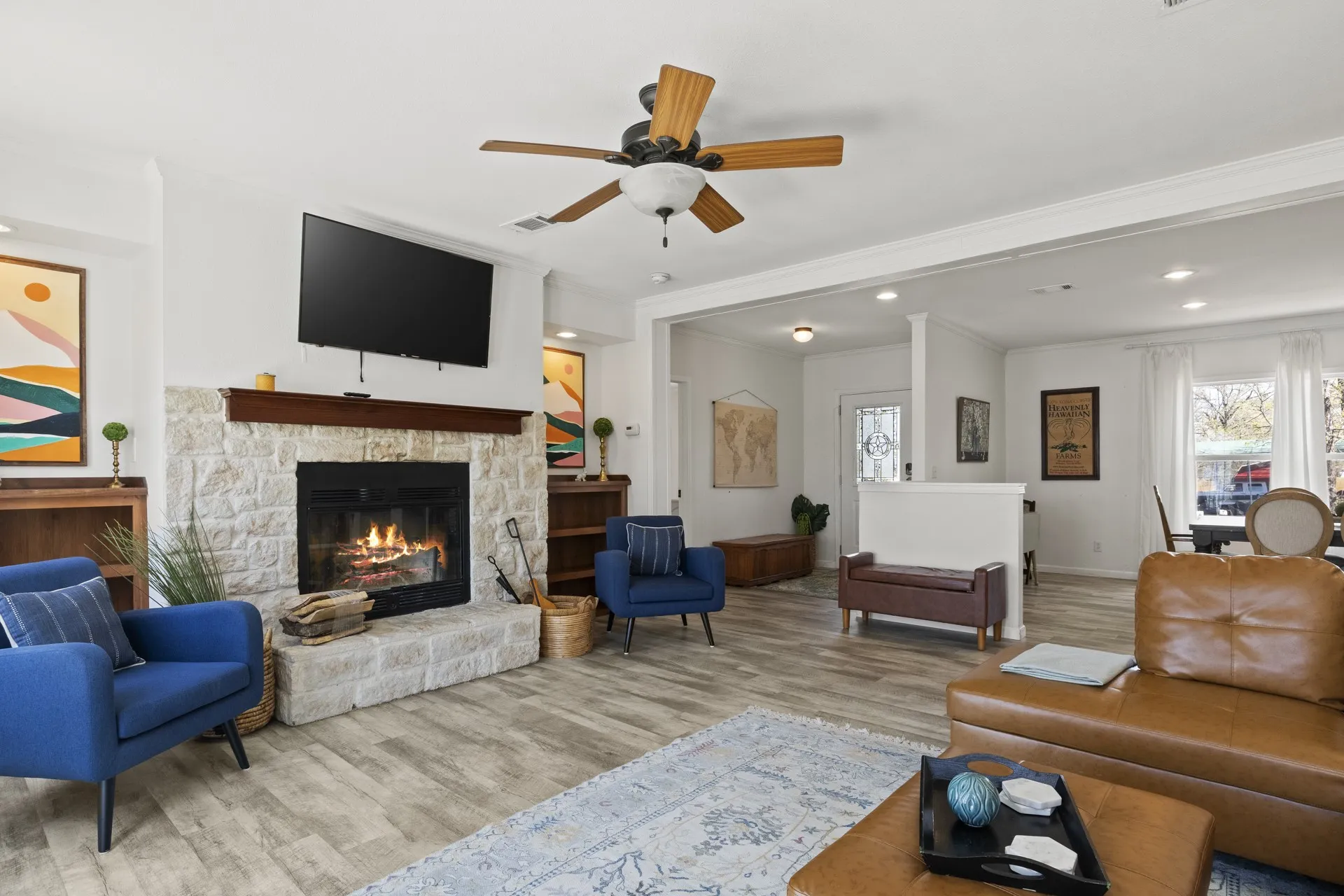 Living room featuring ornamental molding, ceiling fan, hardwood / wood-style flooring, and a fireplace