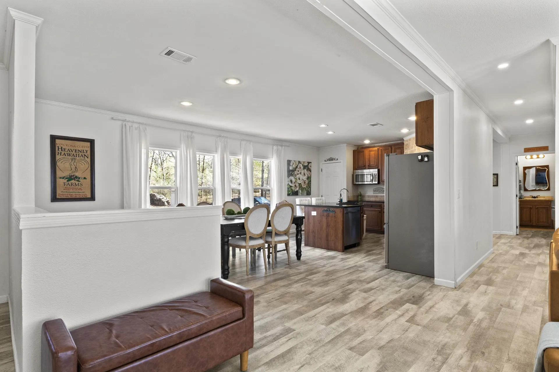 Living room featuring sink, light hardwood / wood-style flooring, and crown molding