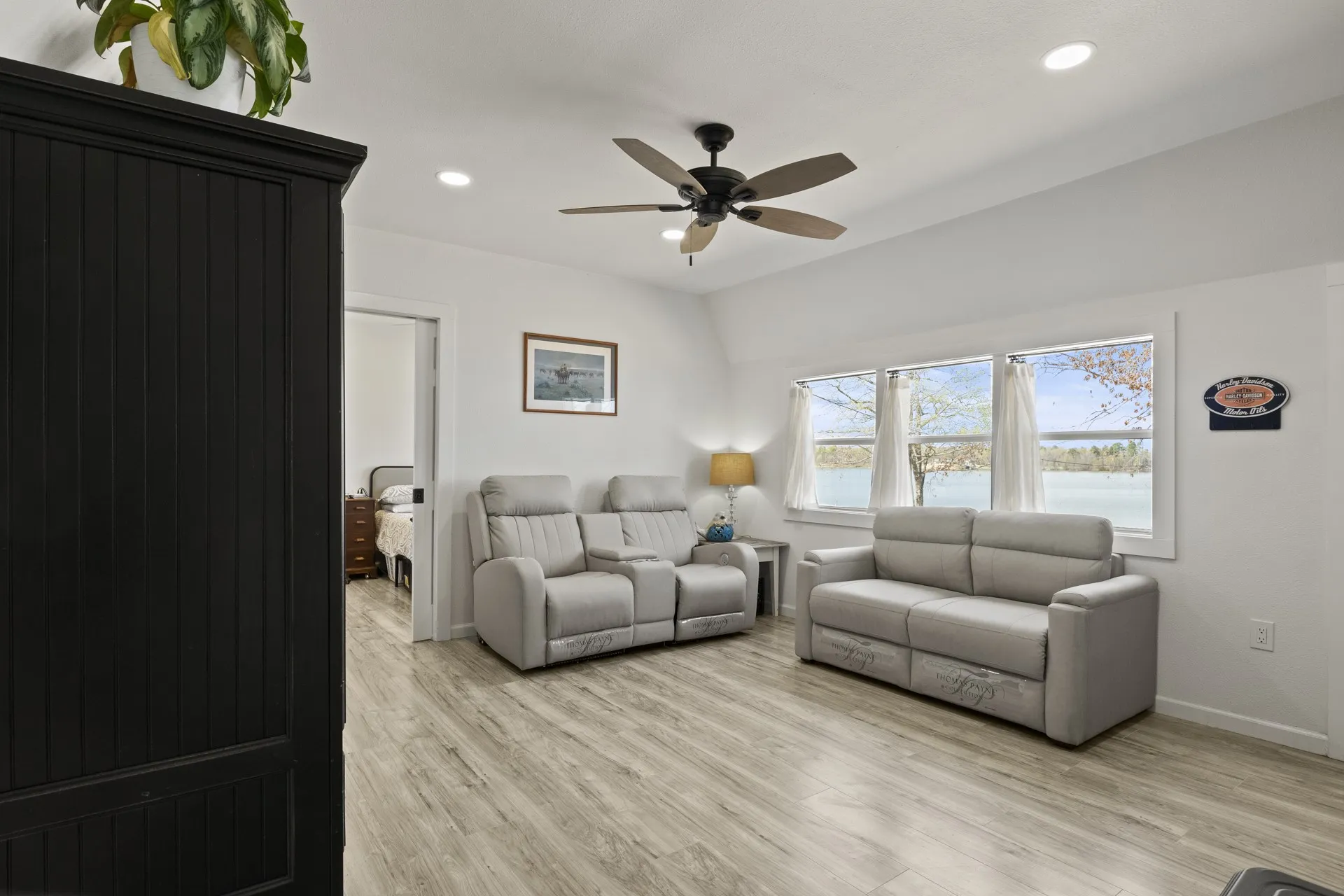 Living room featuring ceiling fan and light wood-type flooring