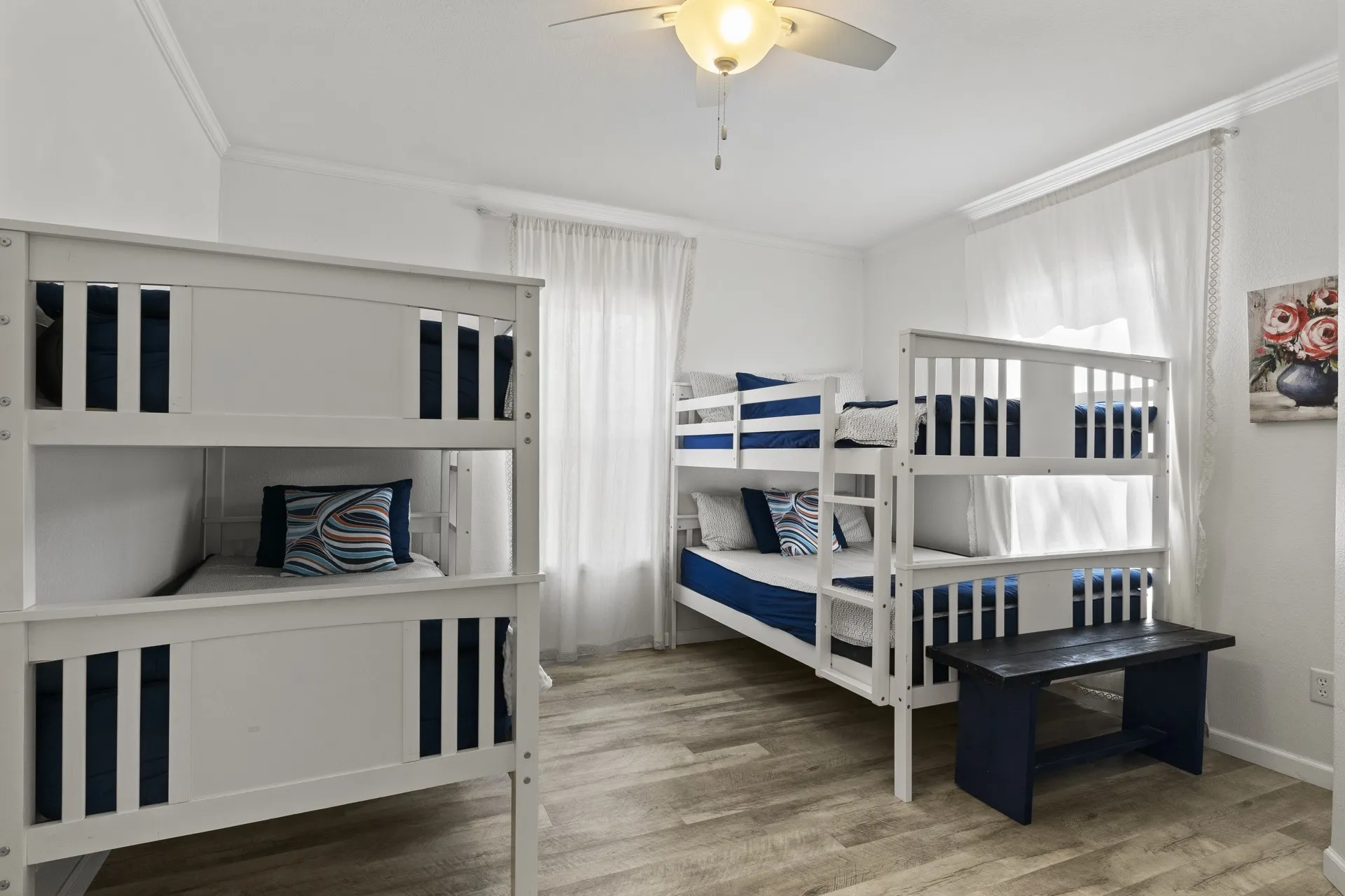 Bedroom with ceiling fan, crown molding, and hardwood / wood-style flooring