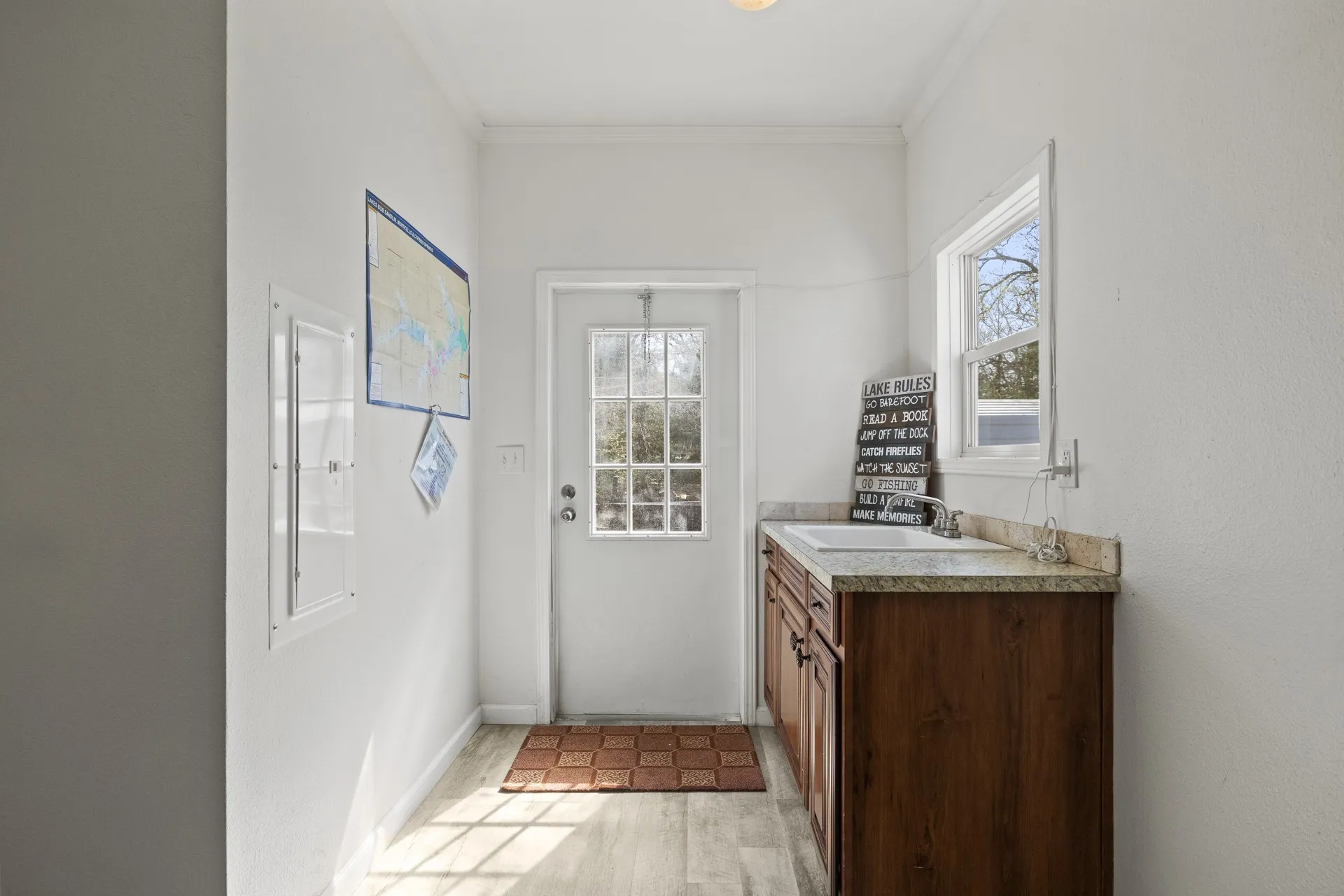 Bathroom featuring plenty of natural light, vanity, crown molding, and hardwood / wood-style flooring