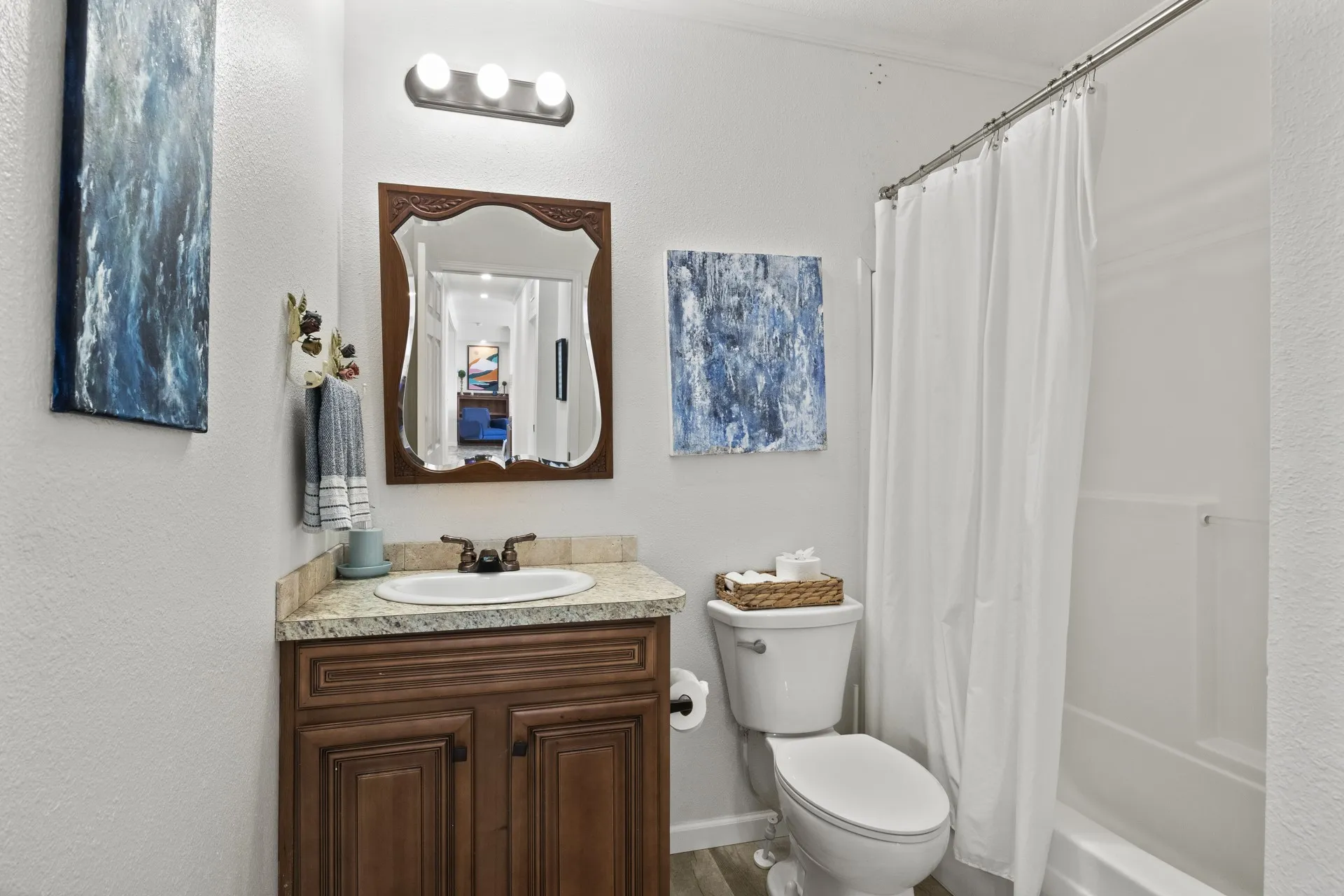 Full bathroom featuring shower / tub combo, vanity, hardwood / wood-style flooring, and toilet