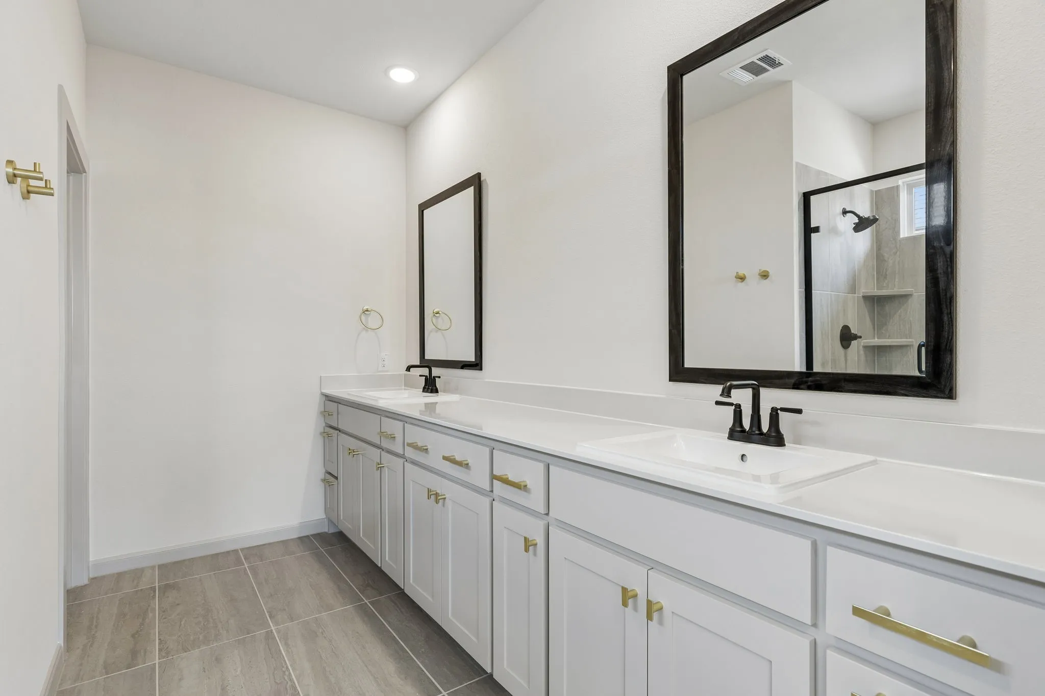 Featuring fantastic storage and dual vanities, this owner's bath offers ample room for two!