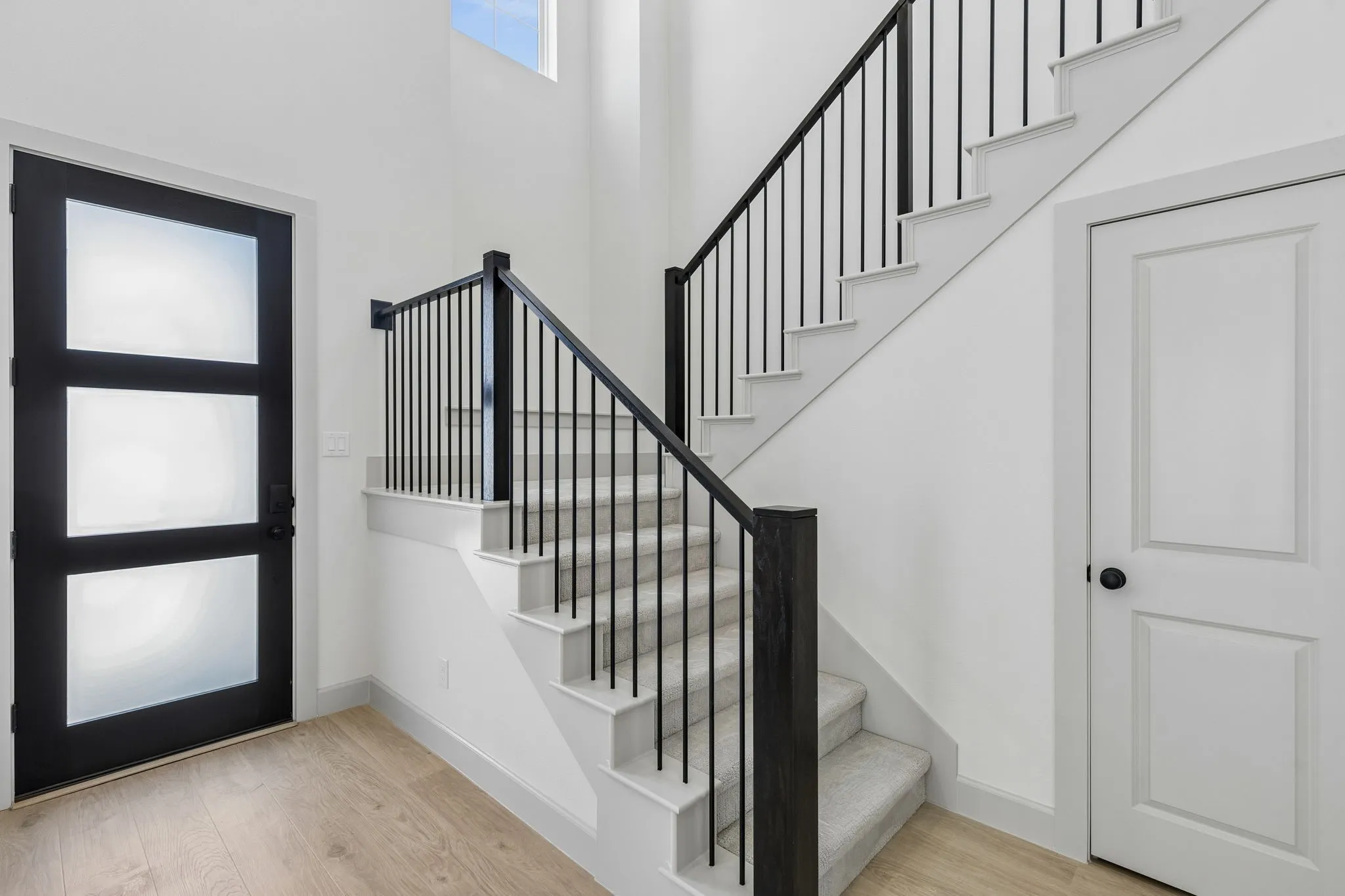 Welcome into your beautiful new dream home featuring light wood-look flooring, elegant stair railings and open sight lines throughout!