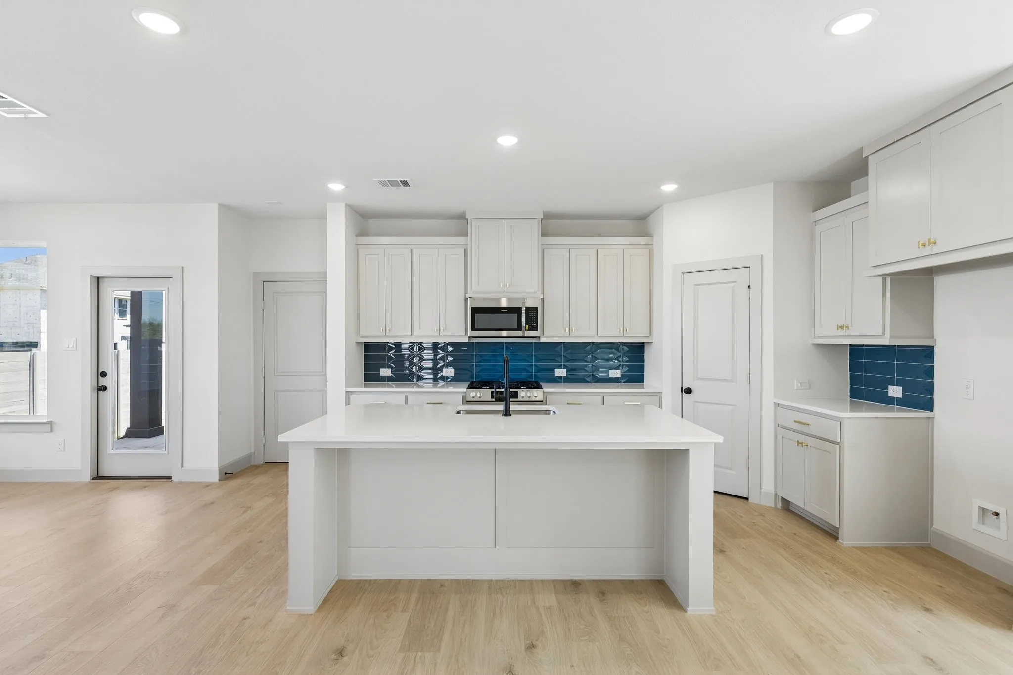 The spacious kitchen island offers the ideal place for family and friends to gather round.