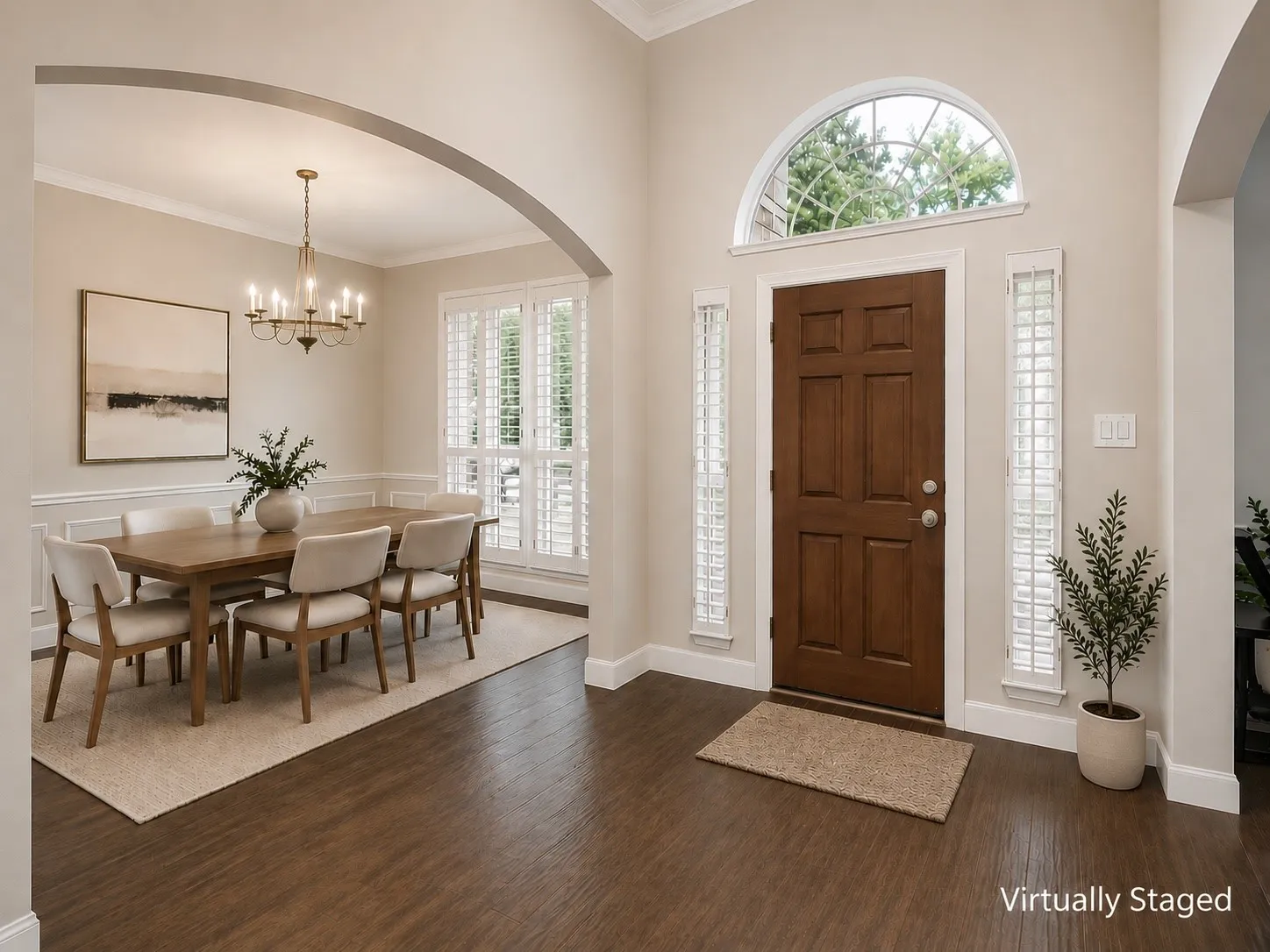 Grand entryway featuring a paneled wood door, arched transom window, and vertical glass block sidelights