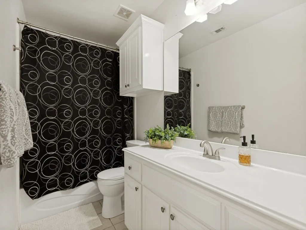 White single vanity with an integrated sink and brushed nickel faucet