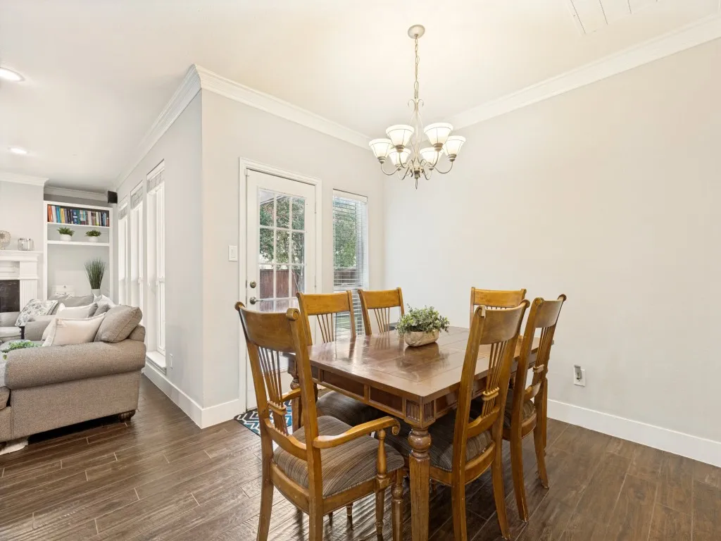 Dining area featuring a classic chandelier and wood-finish flooring