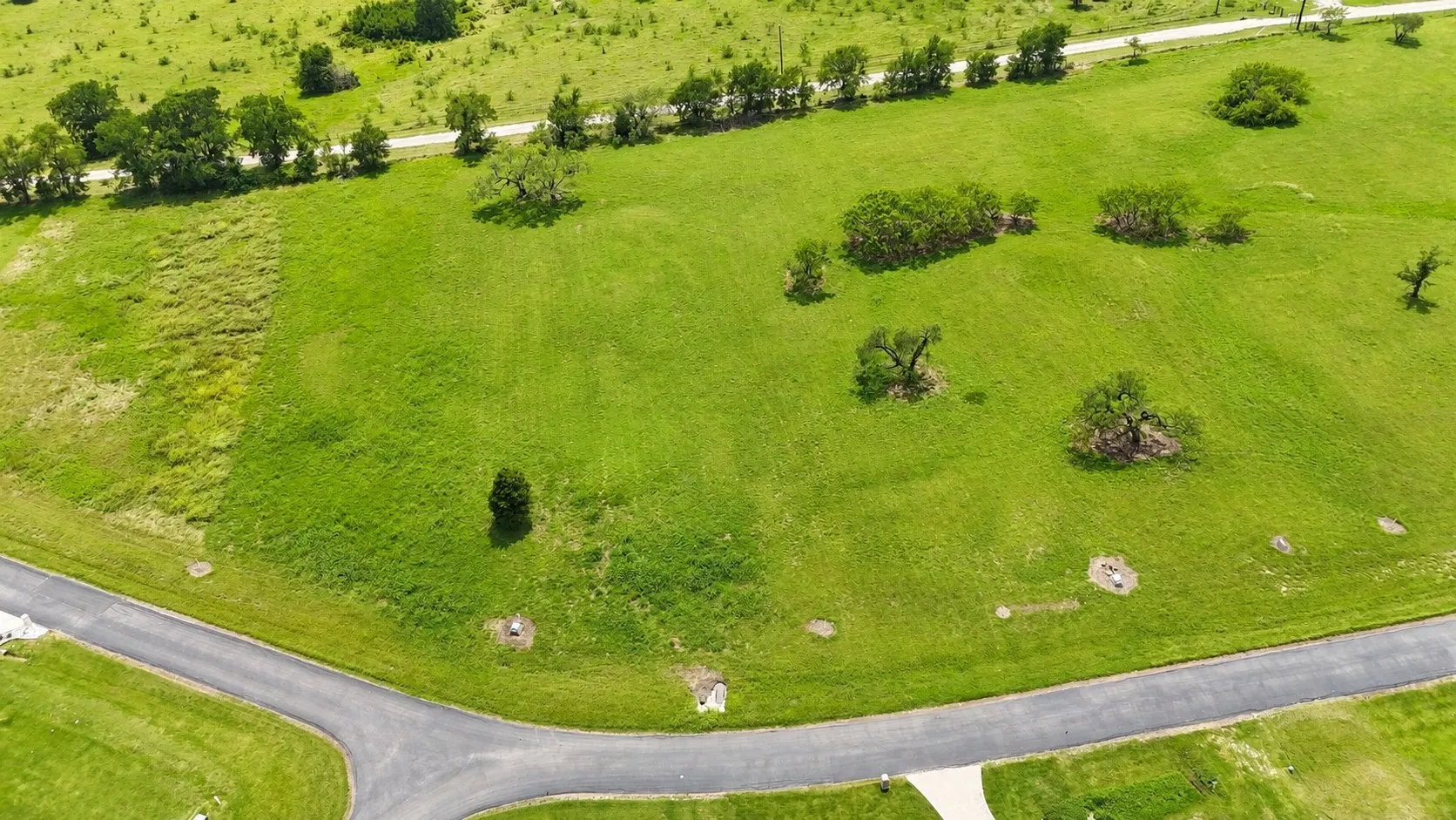 Elevated aerial view of the future homesite within the gated community.