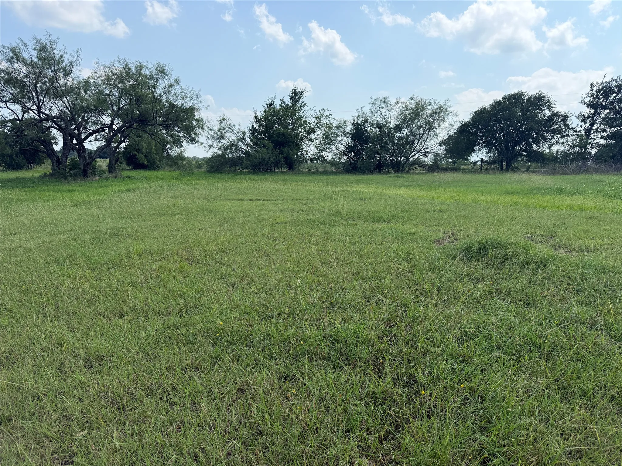 Open meadow-style setting with scenic countryside views.