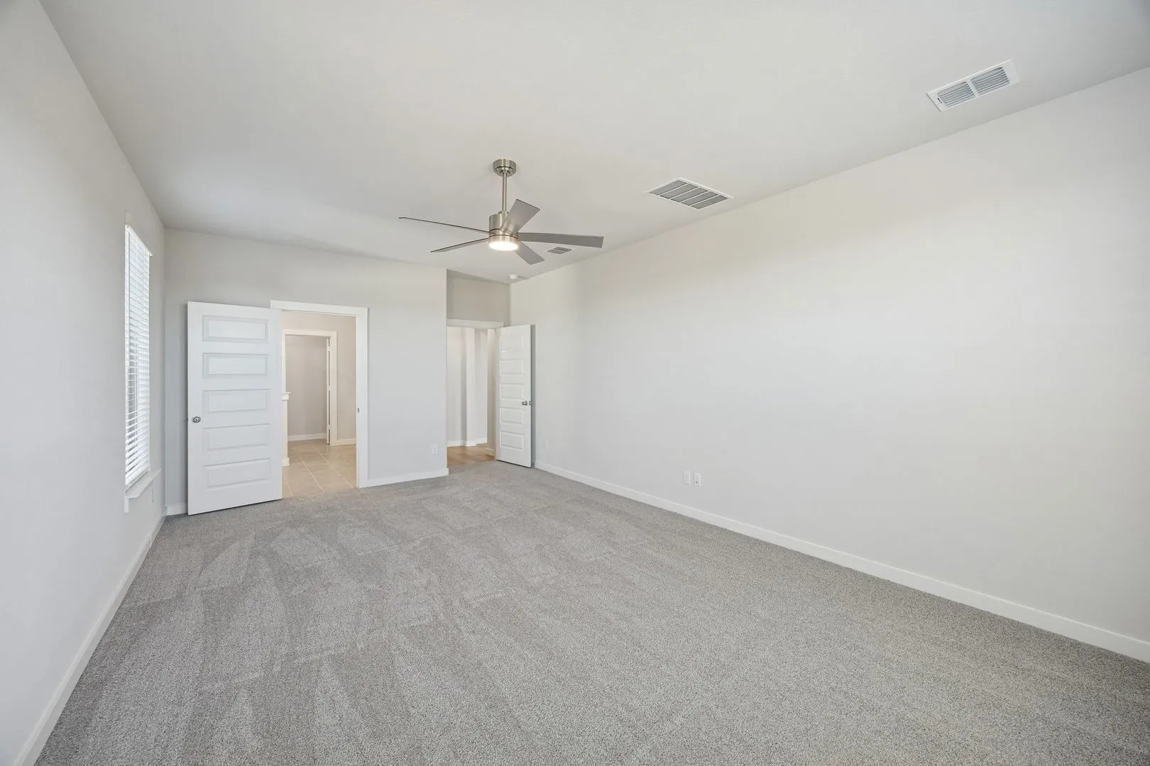Primary Suite in the Wimbledon home plan by Trophy Signature Homes – REPRESENTATIVE PHOTO
