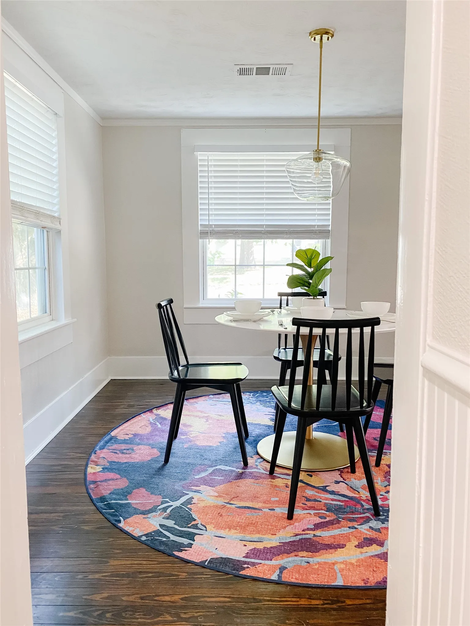 Rich wood-finish flooring complements the crisp white trim and neutral wall tones