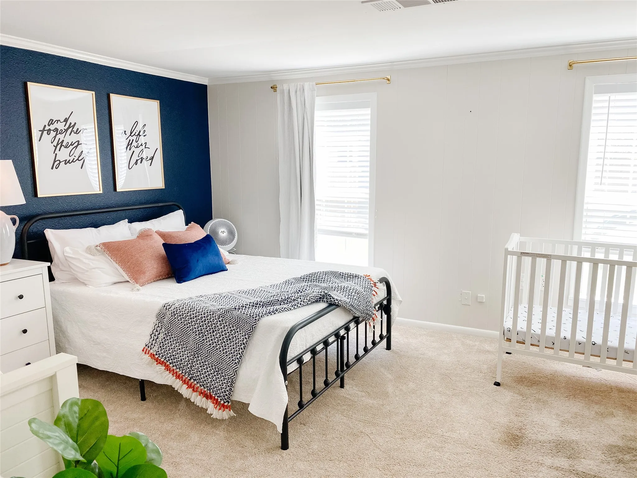 Bedroom featuring carpeted flooring and white walls with a contrasting accent wall