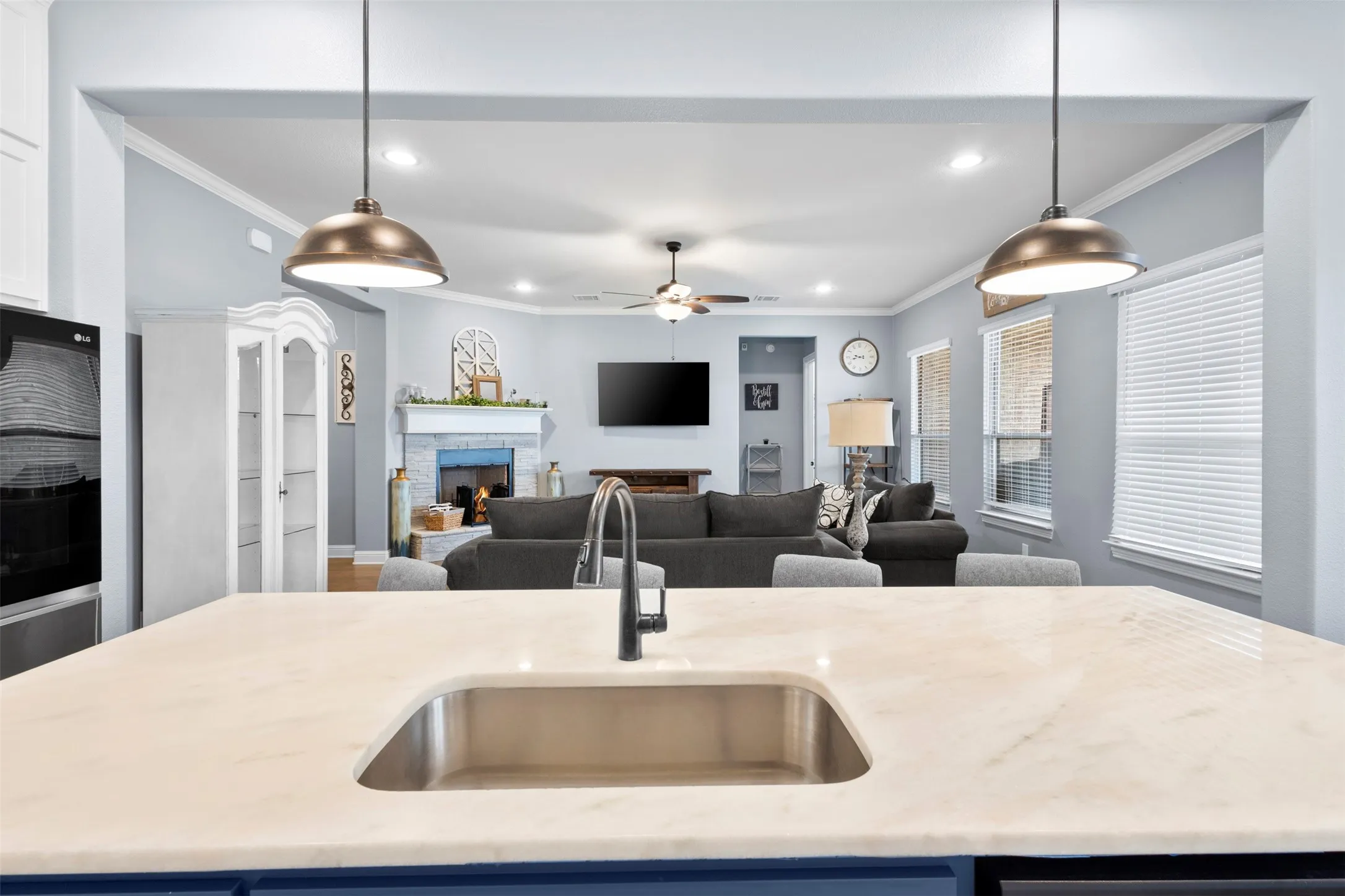 Kitchen island featuring a stainless steel undermount sink and a matte black gooseneck faucet