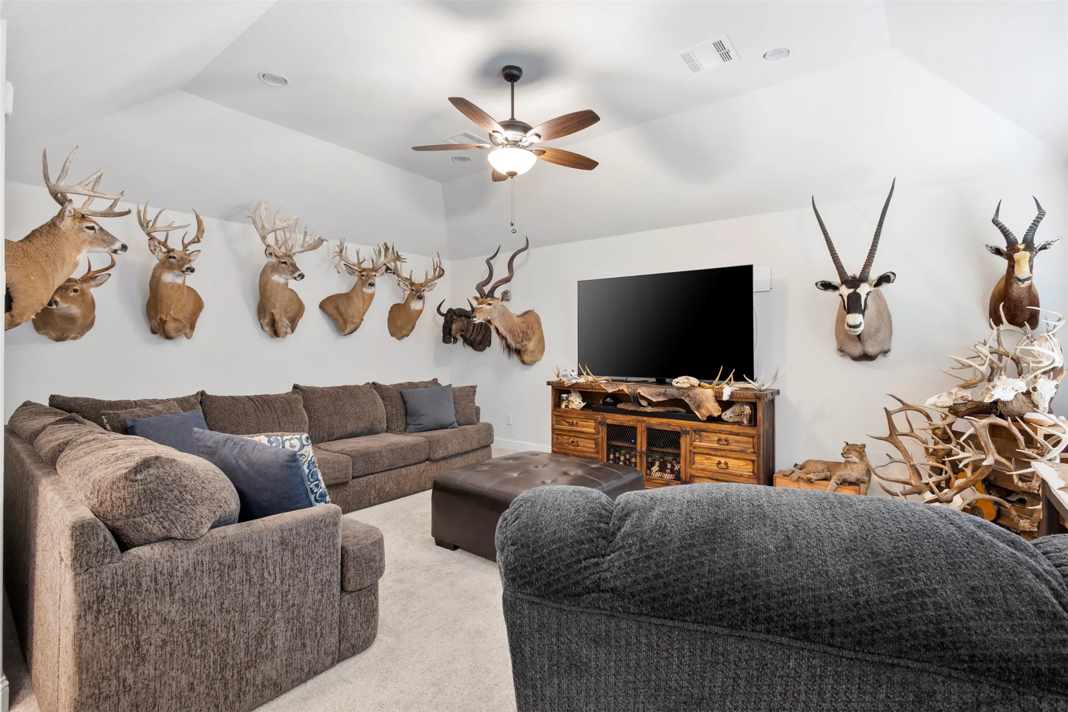 Spacious entertainment area with vaulted ceilings and recessed lighting