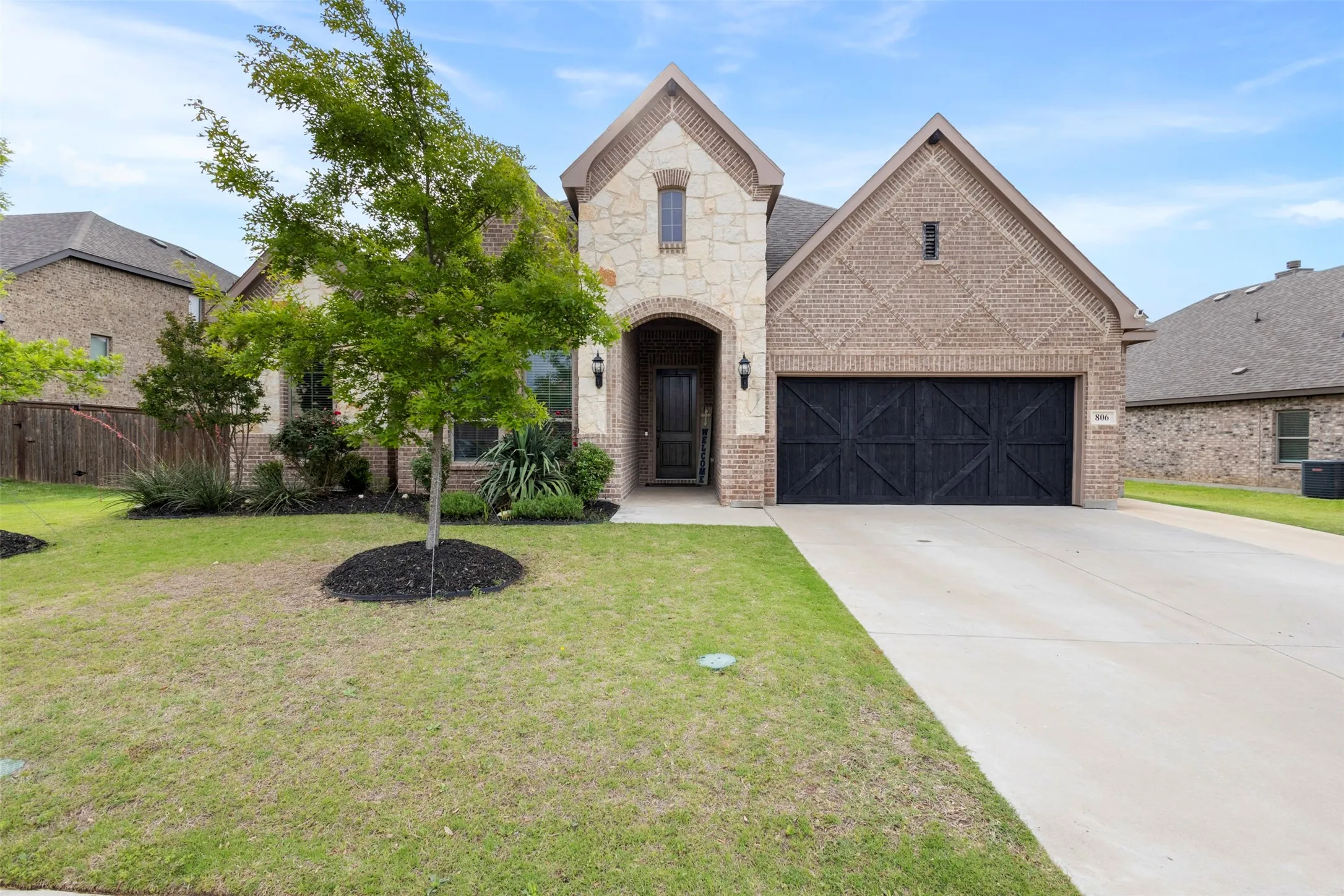 Stone and brick exterior with an arched entryway